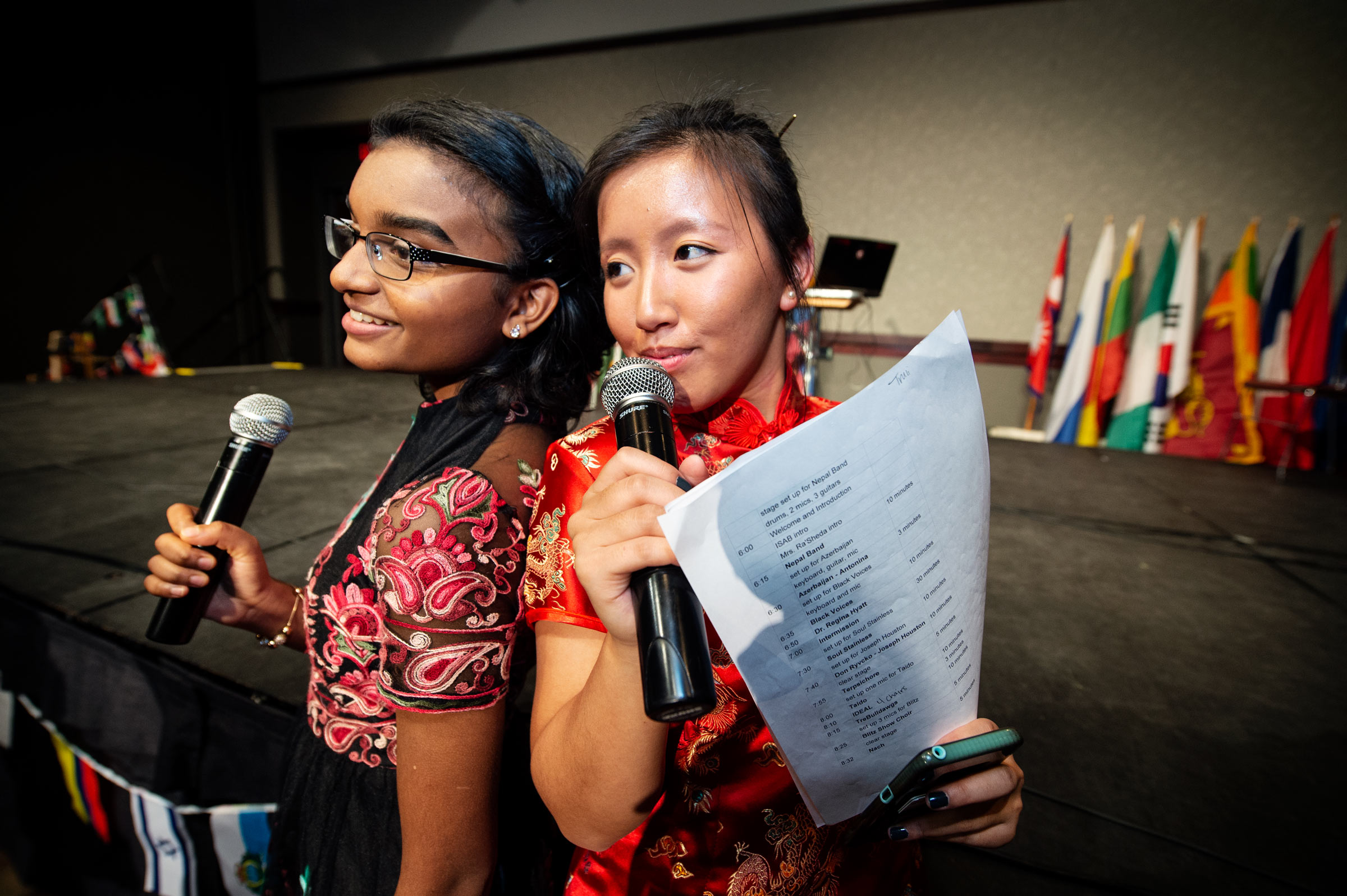 Global Night MCs pose for a photo in front of the stage: Mariat Thankachan and Truli Strickland.