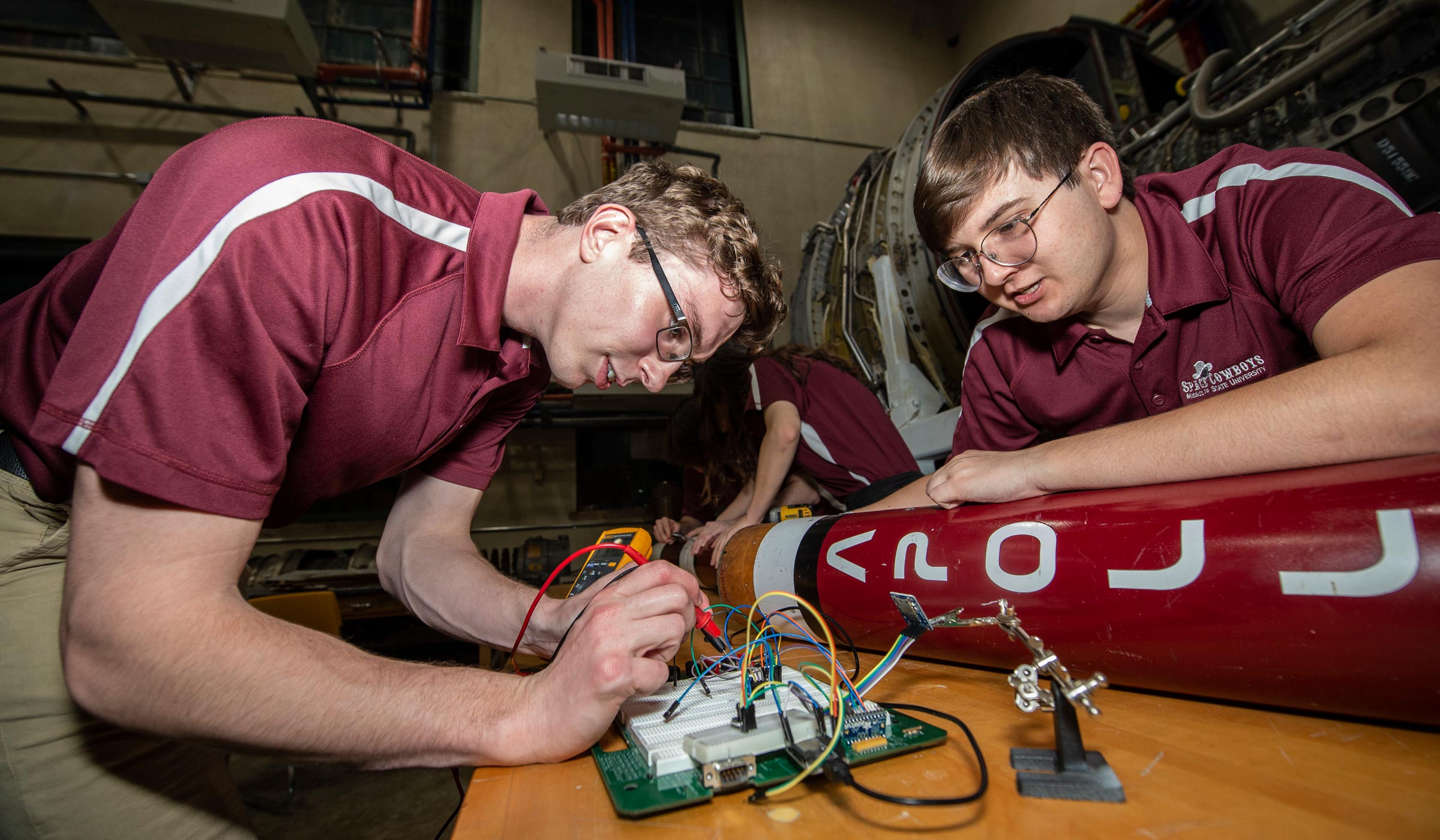 Spencer Lampkin (sl1611) and Chase Wornex (cww209) work on a rocket during a Space cowboys meeting.