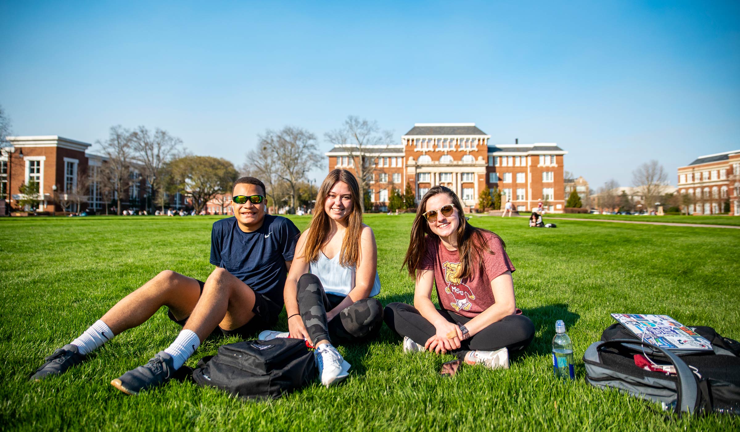 Cameron Taylor, Abigail Duke and Katelyn Gibbs all pose for a photo while on the drill field.