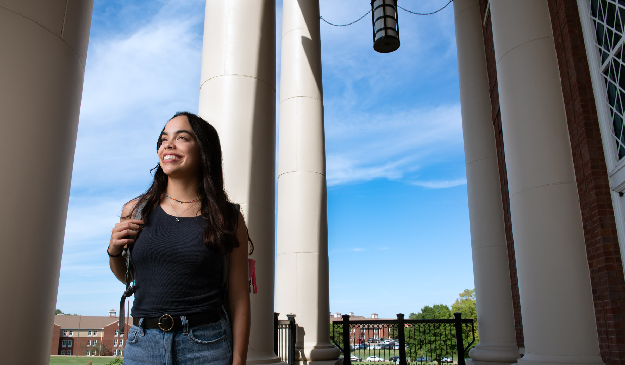 Laura Alvarez Rios, pictured in front of the tall columns at Old Main Academic Center