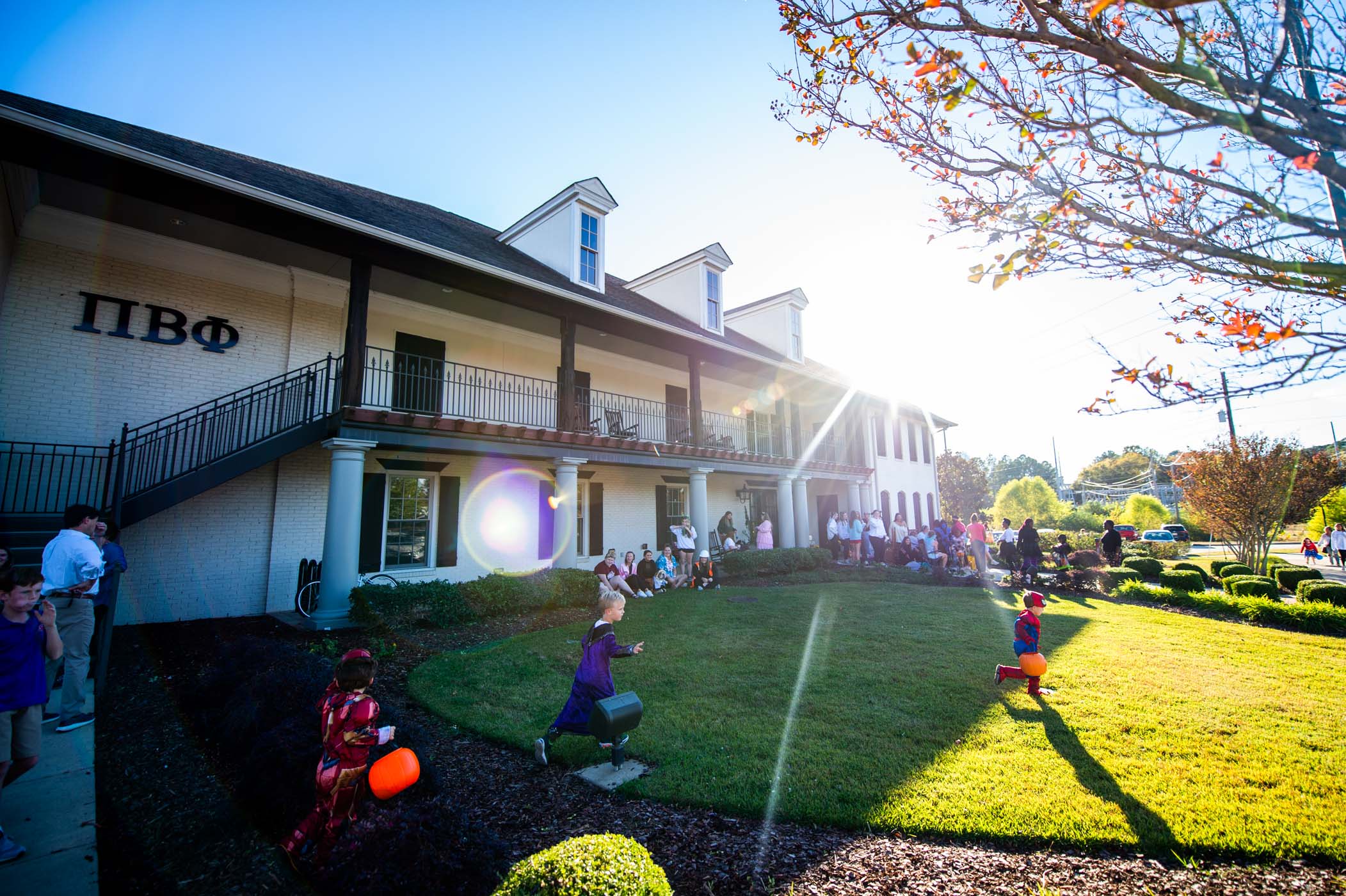 Happy Trick-or-Treater run across MSU Pi Beta Phi&#039;s front lawn to fill their treat buckets with candy from the Greek Life community