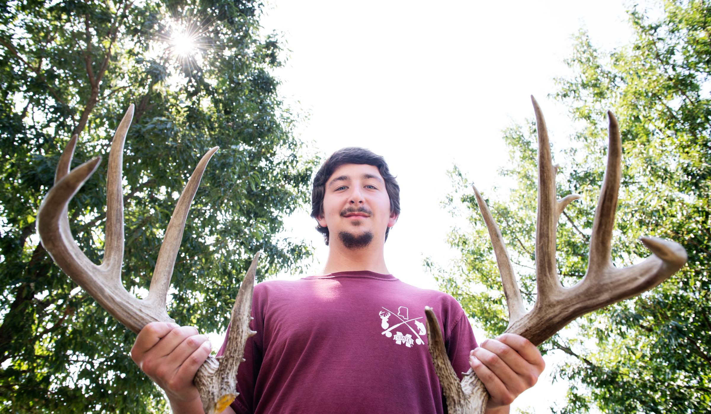 Picture of Nathan Cowley holding deer antlers