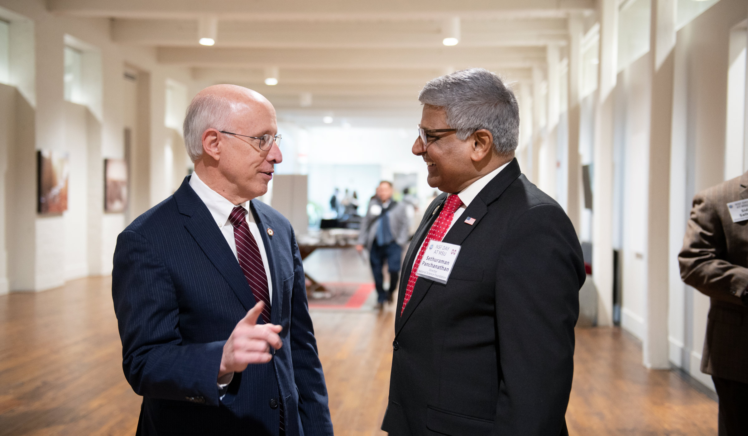 Provost Shaw and NSF Director Panchananthan visit in the hall of The Mill before the NSF Day program.
