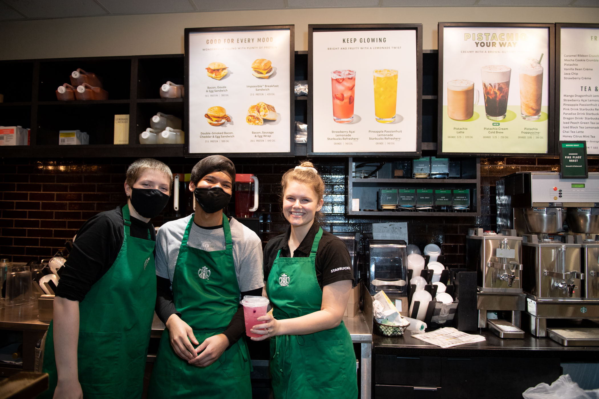 Staff of MSU&#039;s Starbucks, located inside Colvard Student Union, smile for the camera while showing off one of many drink options on the menu.