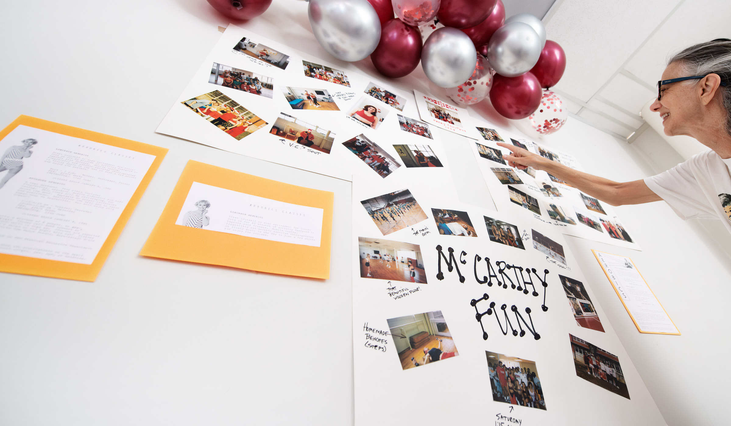 With &quot;McCarthy Fun&quot; in focus and balloons on top, a wall is covered with old photos and flyers from aerobics classes held in the McCarthy Gym studio in the 1980s and 1990s.