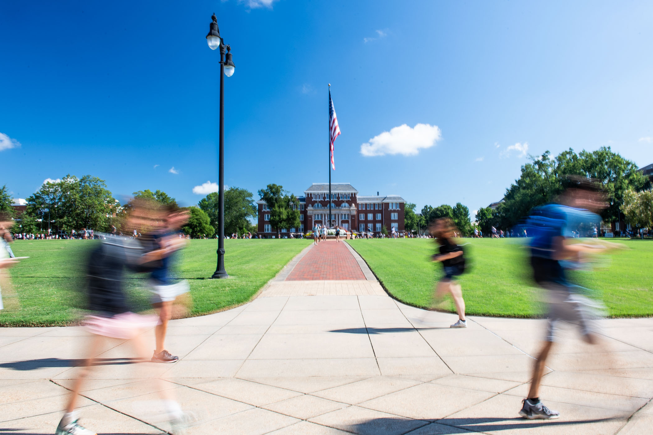 Students cross the Drill Field in between classes on the first day of the fall 2023 semester. 