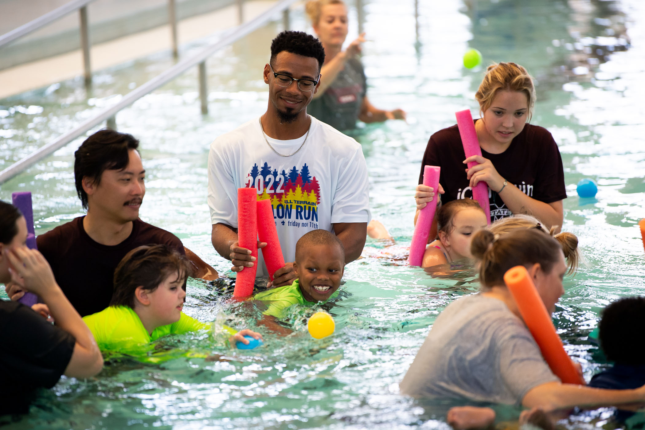 Staff members of MSU&#039;s Kinesiology department help participating students of the program&#039;s Adapted Swim Camp build confidence and skills in the Sanderson Center pool.