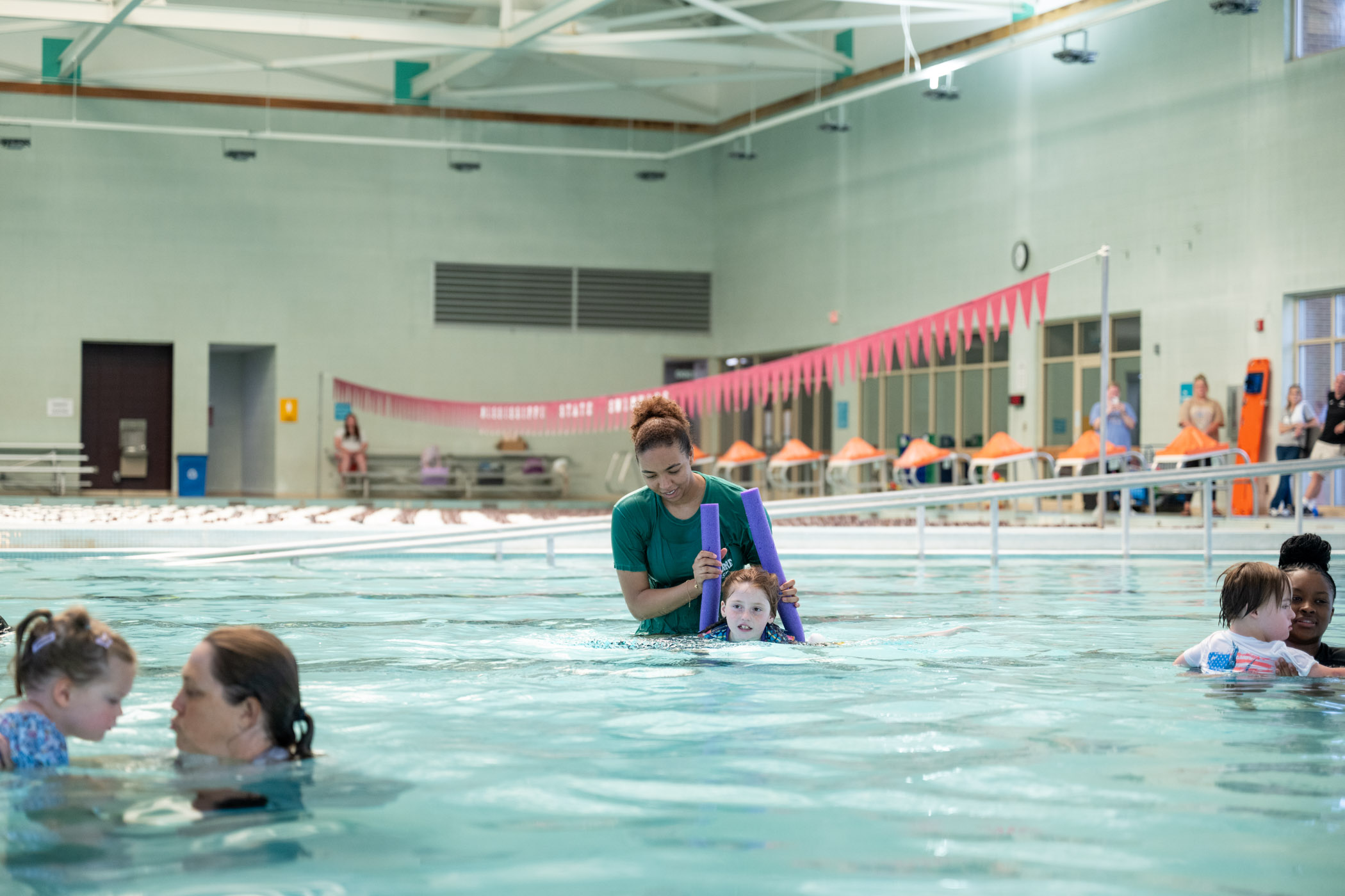 Hiba Bouchareb, a doctoral student studying mechanical engineering from Morocco, teaches Presley Porch valuable swimming skills recently during the MSU Adapted Swim Camp at the Sanderson Center. Certified camp staff and student volunteers in the Department of Kinesiology help participants work toward their individual aquatic goals while emphasizing water safety during the five-day event.