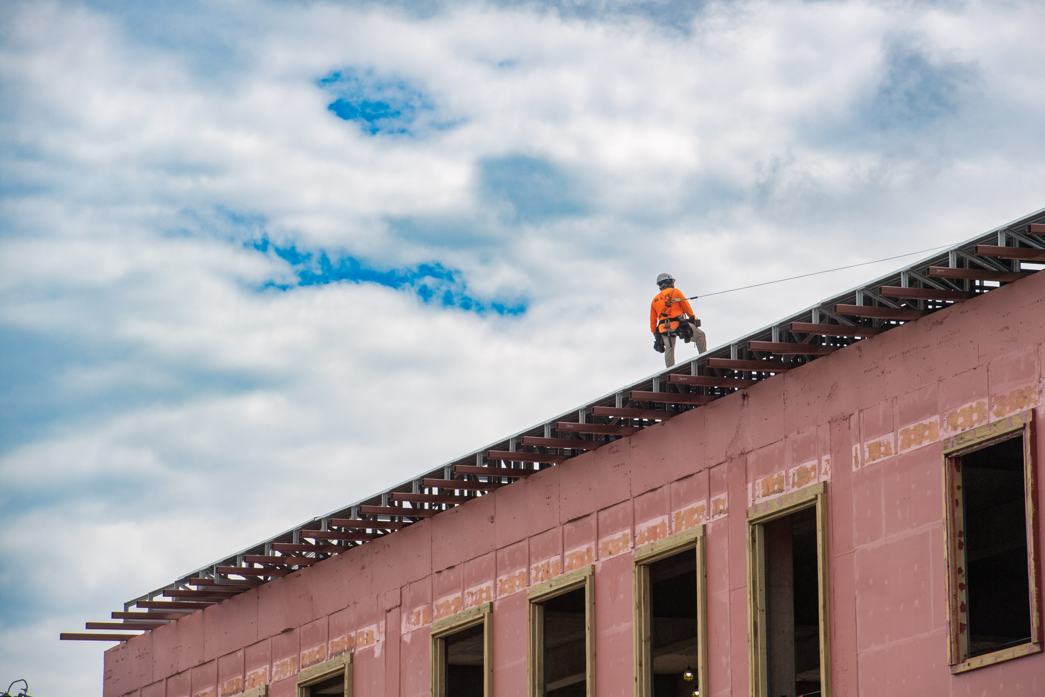 A worker stands high above campus Friday [June 28] as construction of the Jim and Thomas Duff Center, the future home of Mississippi State&#039;s Autism and Developmental Disabilities Clinic, continues. Slated to open in 2025, the 100,000-square-foot facility also will house programs of the MSU Disability Resource Center and Department of Kinesiology.