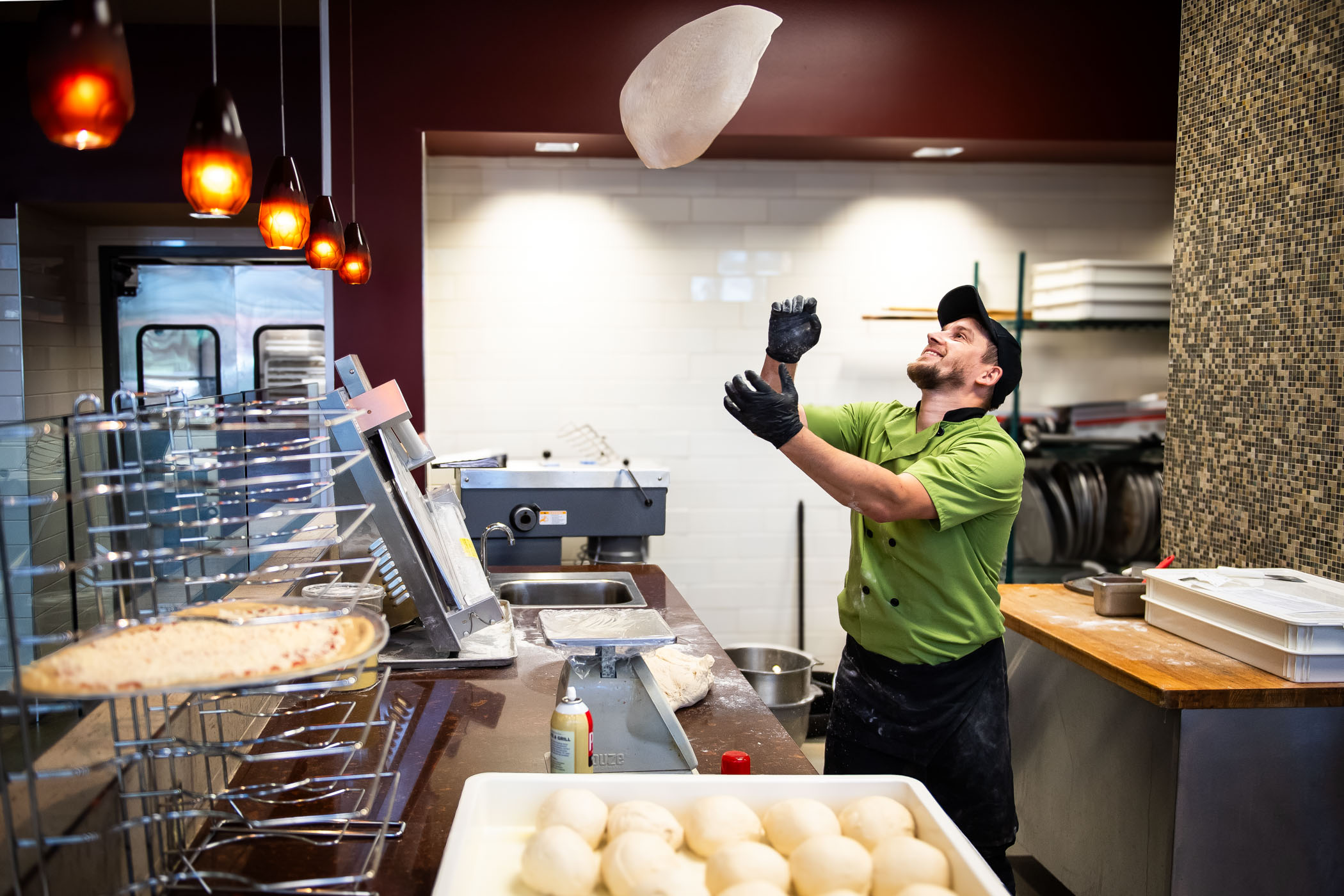 Vasyl Shramenko making pizza dough