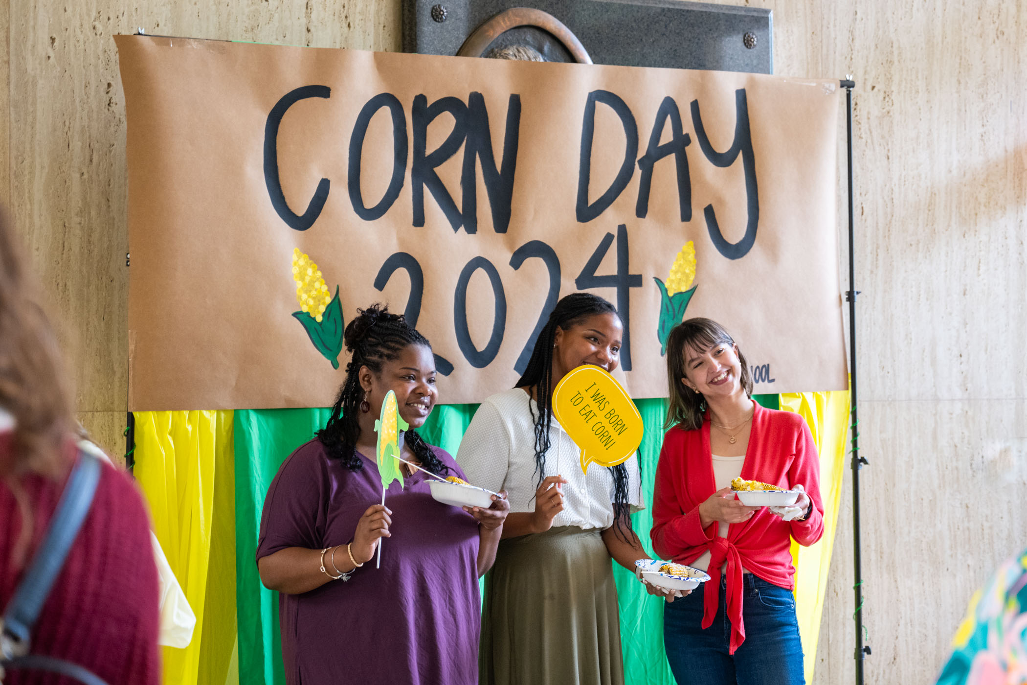 Three participants pose during the MSU Graduate School’s Corn Day celebration Tuesday [July 9] in Allen Hall’s lobby. The event provided more than 250 ears of grilled corn grown at MSU’s North Farm to graduate students and served as a welcome break from their summer studies.