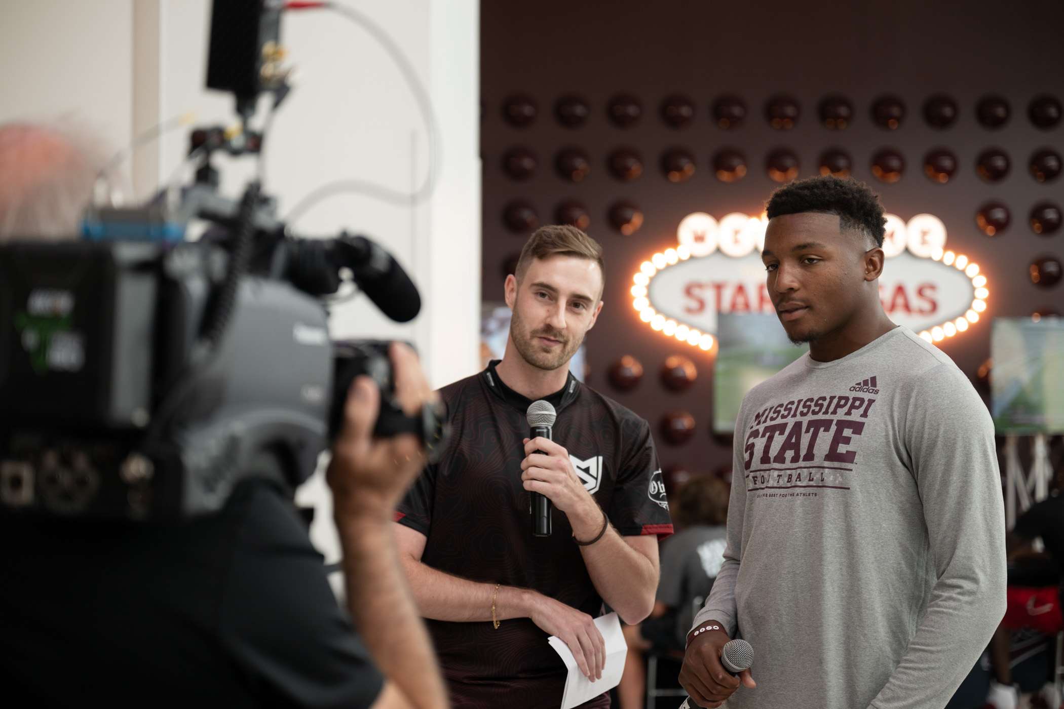 MSU Esports representative and alumnus Bailey Pulliam, left, and Isaac Smith, a sophomore safety from Fulton, host a live stream of gaming Thursday [July 18] at The Hump as fans celebrate the release of EA Sports’ College Football 25. Players competed in a 32-bracket playoff for their chance to win a cowbell, helmet and football all signed by head coach Jeff Lebby.