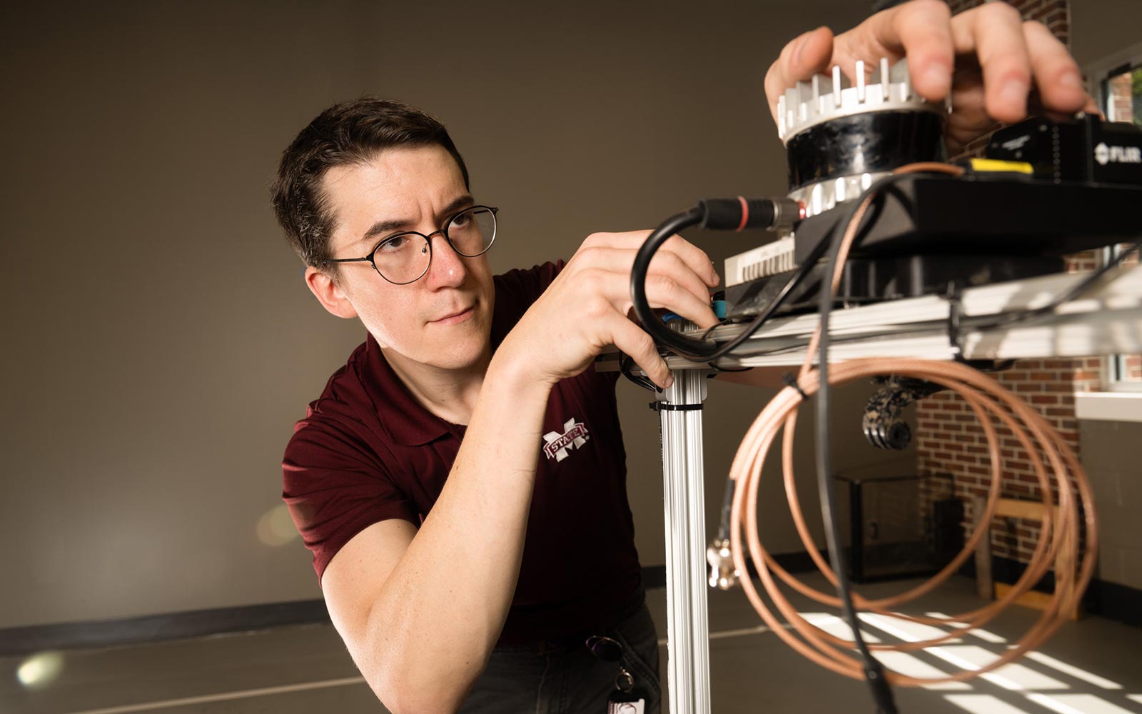 Marc Moore works on an autonomous robot he built