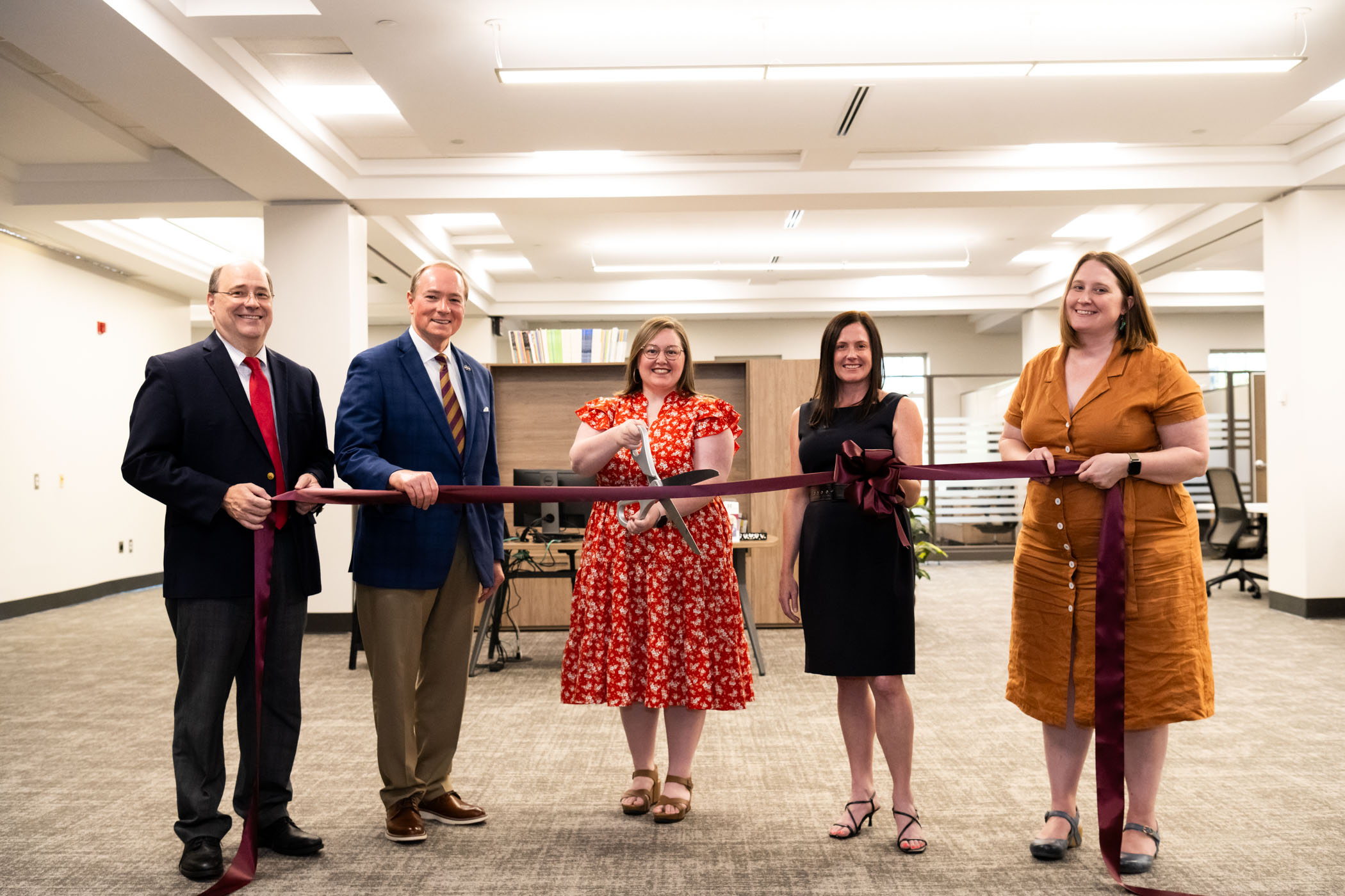 MSU leaders celebrate the ribbon cutting for the university&#039;s Writing Center, now located on the second floor of Mitchell Memorial Library. Pictured, from left, are College of Arts and Sciences Dean Rick Travis, MSU President Mark E. Keenum, Writing Center Director Loreeda Rios, MSU Libraries Dean Lis Pankl and Department of English Head Lara Dodds. (Photo by Grace Cockrell)