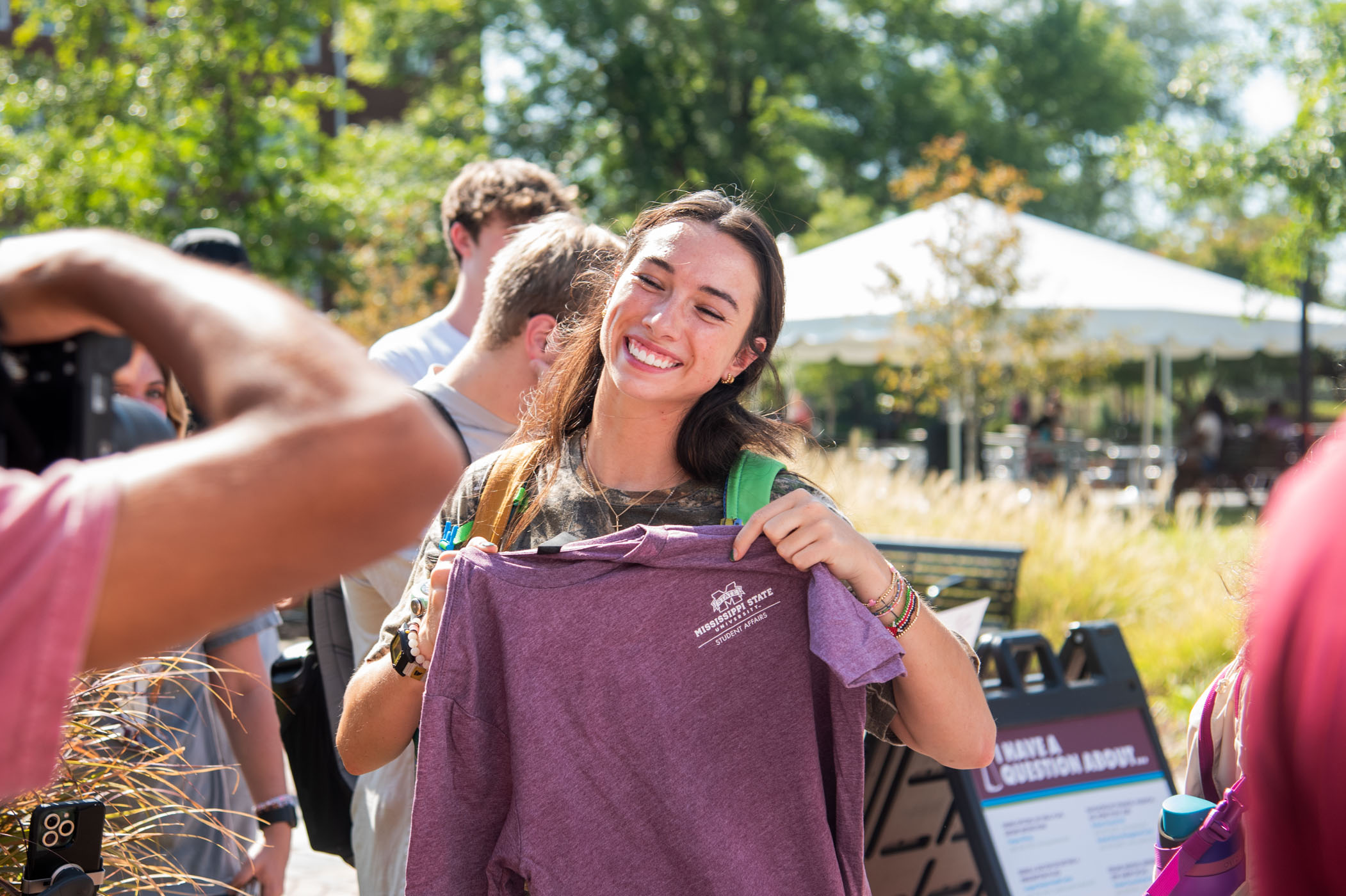 Payton Hurst, a sophomore agricultural science major from Pearland, Texas, flashes a smile with her new Mississippi State gear at Maroon Friday Freebie Frenzy, an annual event hosted by the MSU Student Association and Hail State Style.