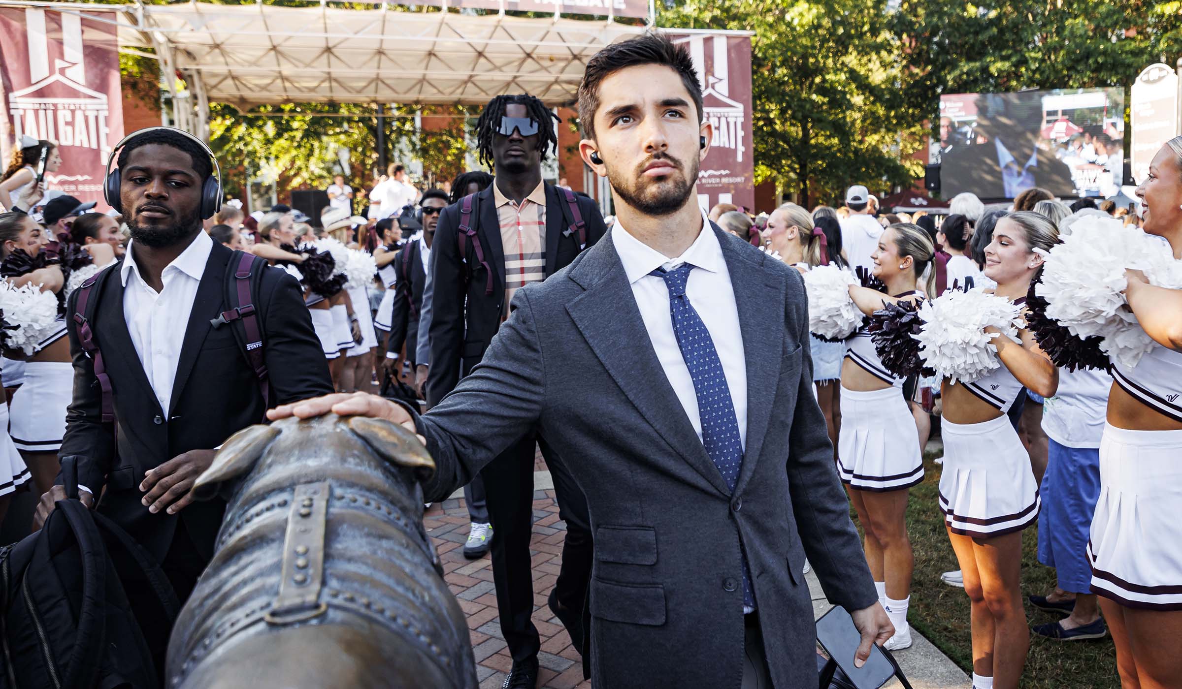 Nick Barr-Mira walks through the Junction and touches the statue of Bully before a home football game.