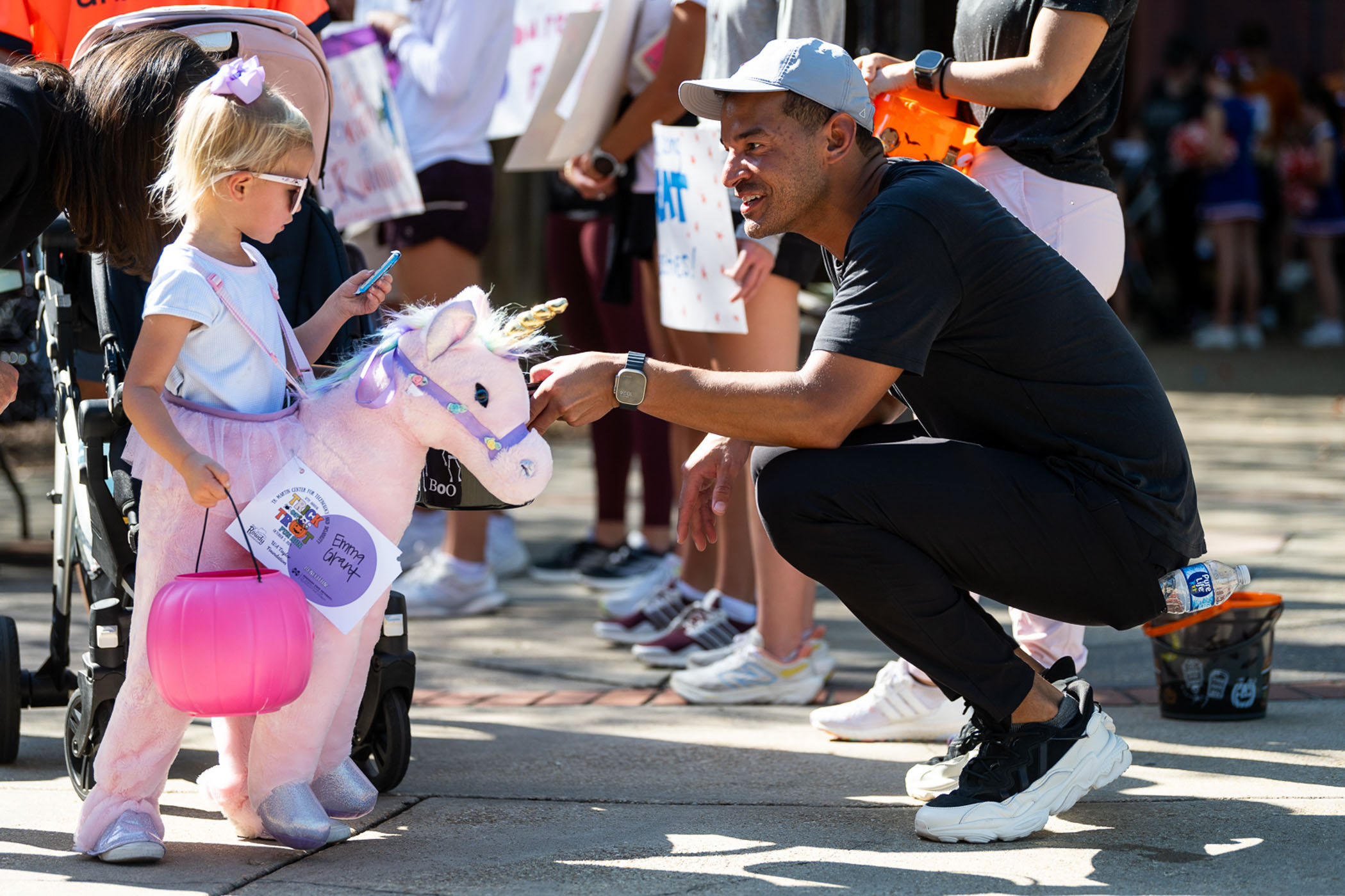 Mississippi State Director of Athletics Zac Selmon passes out candy to a participant in the T.K. Martin Center for Technology and Disability’s 12th annual Trick or Trot fun run Saturday [Oct. 5]. The community event is the center’s largest fundraiser and benefits Project IMPACT, a special education program.