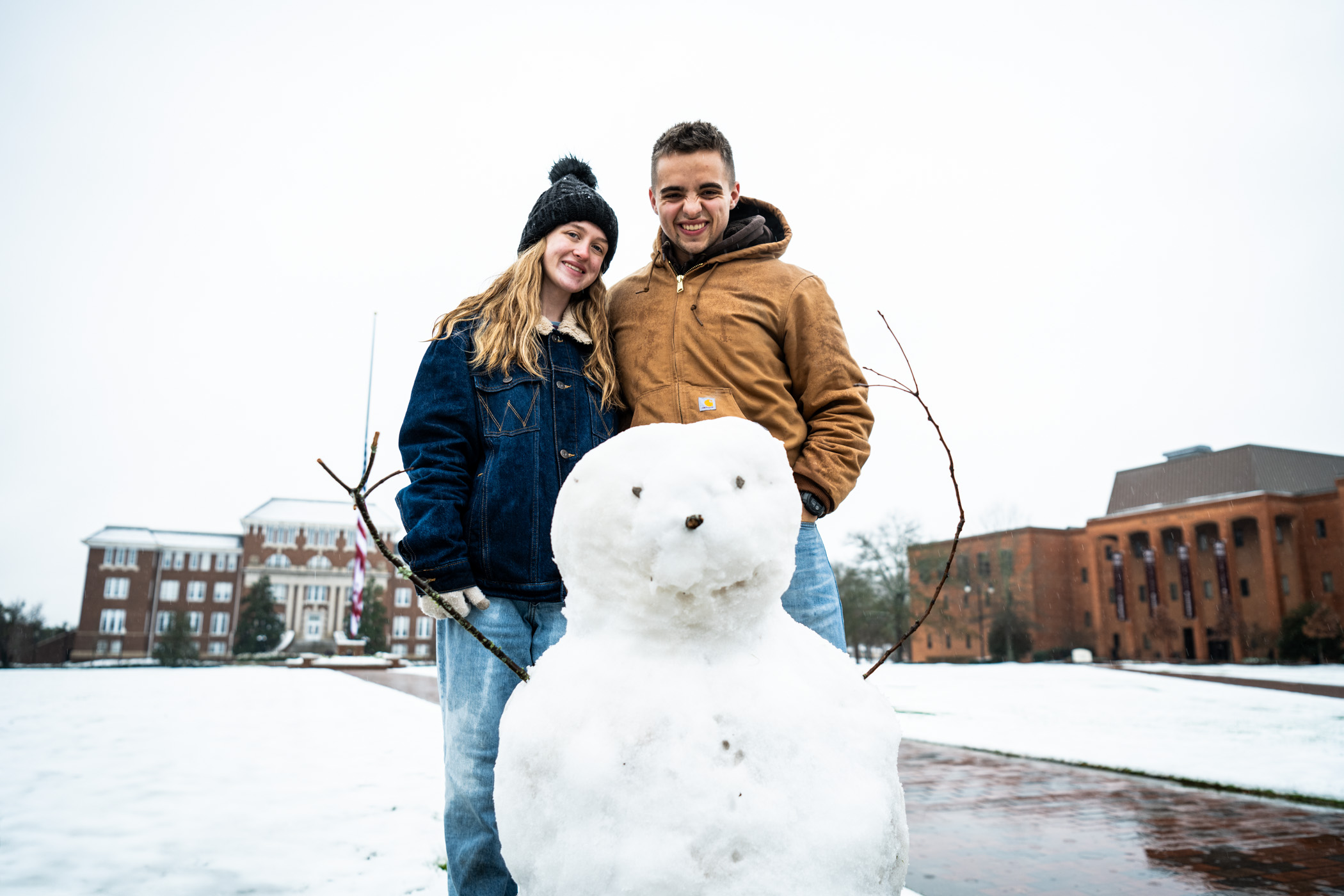 Rachel Apperson, a Psychology student from Meridian and Parker Dickinson, an Animal and Dairy Sciences student from Collinsville smile with their completed snow day project: a snowman named &quot;Harold.&quot; Rachel and Parker were among many MSU community members out enjoying the rare Mississippi winter wonderland. 