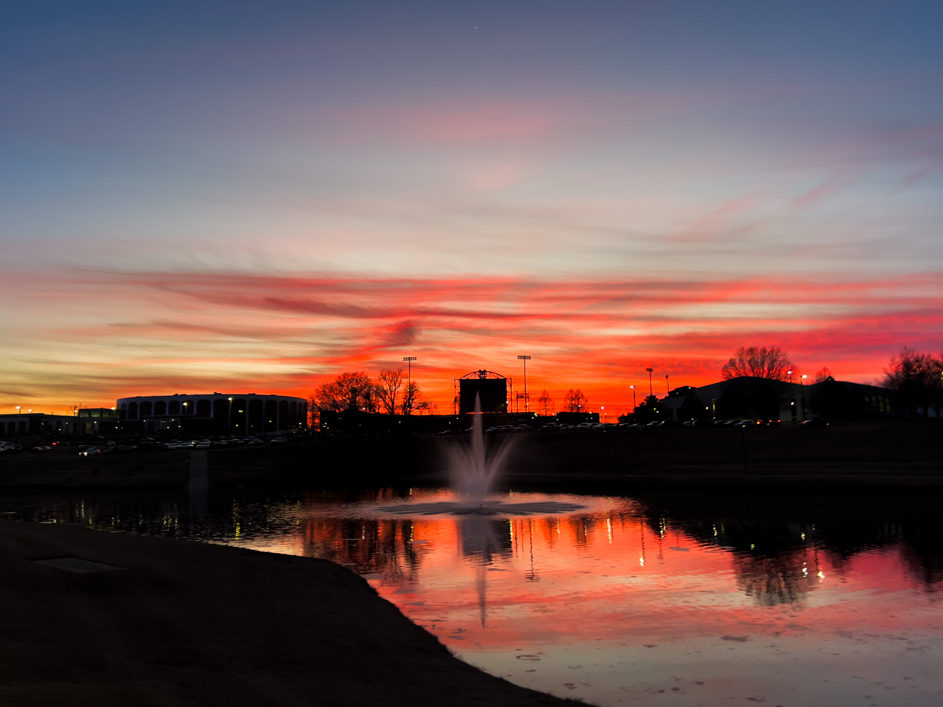 A vibrant evening sunset paints the skies over MSU&#039;s Chadwick Lake walking trail and the athletic district, a perfect preview of longer days and warmer opportunities to exercise for outdoor recreationalists on campus.