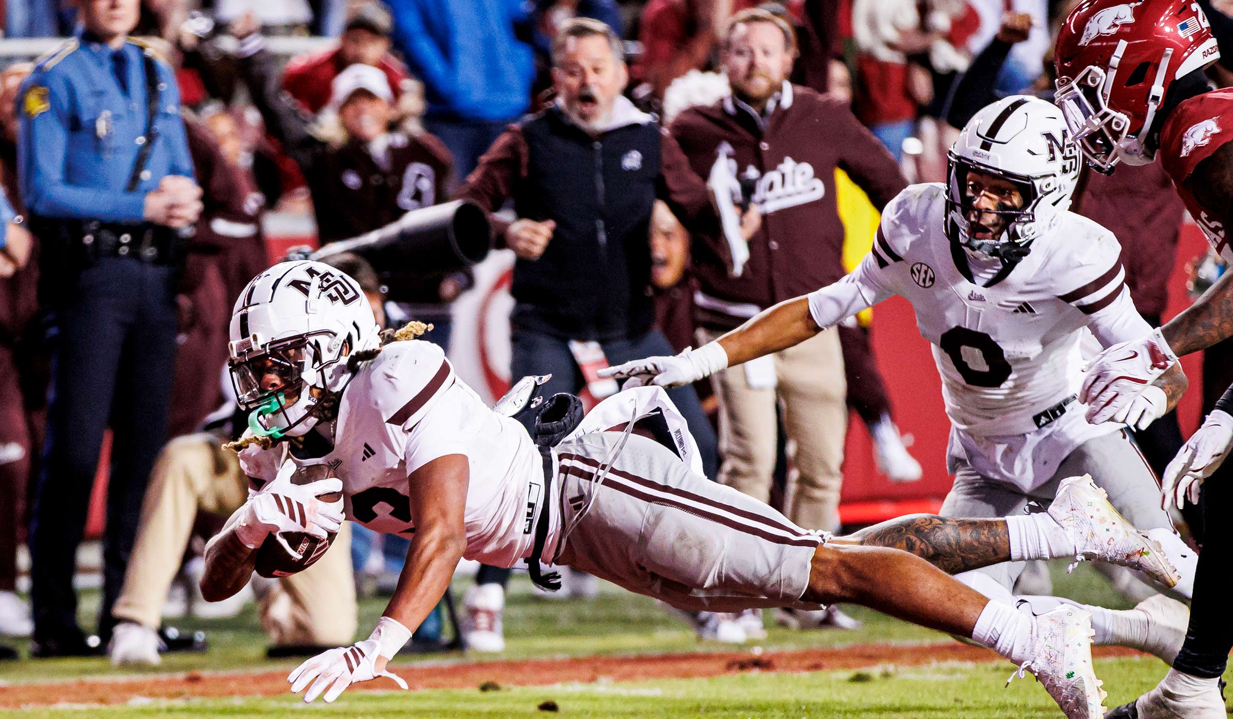 Football player diving across goal line with football