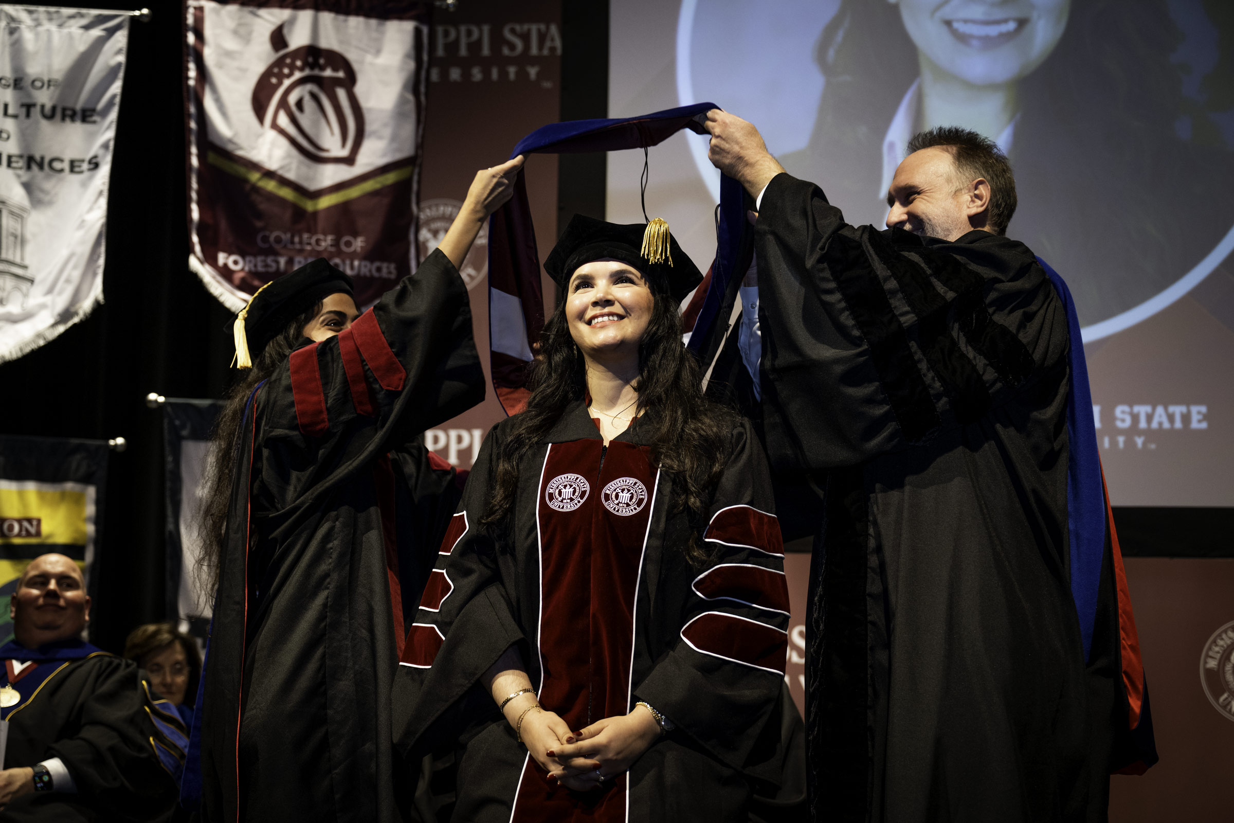 Lamiae Taoudi, a PhD candidate of MSU's Bagley College of Engineering, is hooded by Dean Dr. David Ford (right) and Dr. Nazanin Tajik (left) at the fall 2025 Doctoral Commencement Ceremony on Thursday, [Dec 11.] The hooding ceremony is one of three commencement events happening at the Starkville campus, with two ceremonies on Friday [Dec. 12]—9:30 a.m. and 2:30 p.m.—in Humphrey Coliseum.   