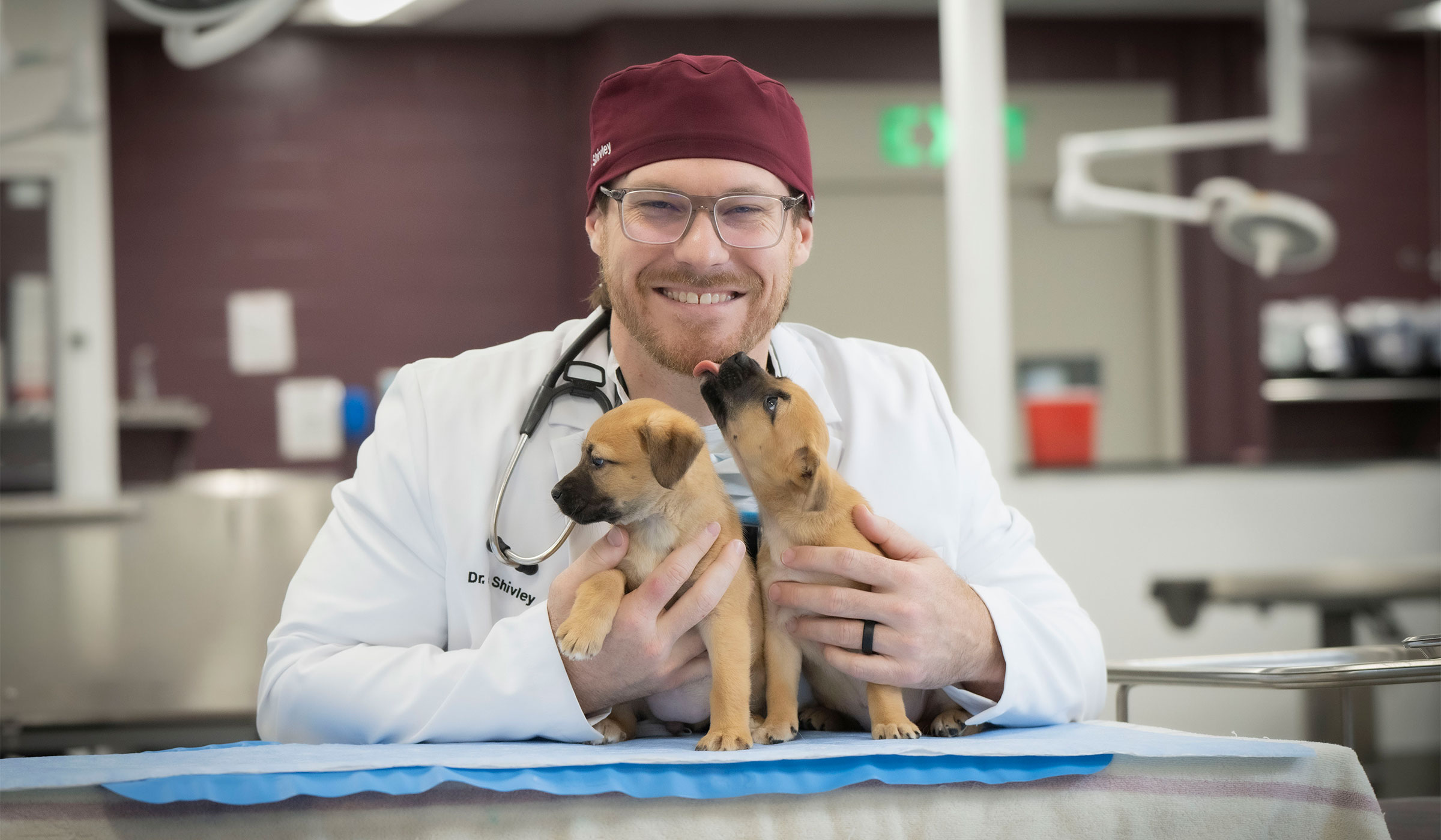 Dr. Jake Shivley with two puppies
