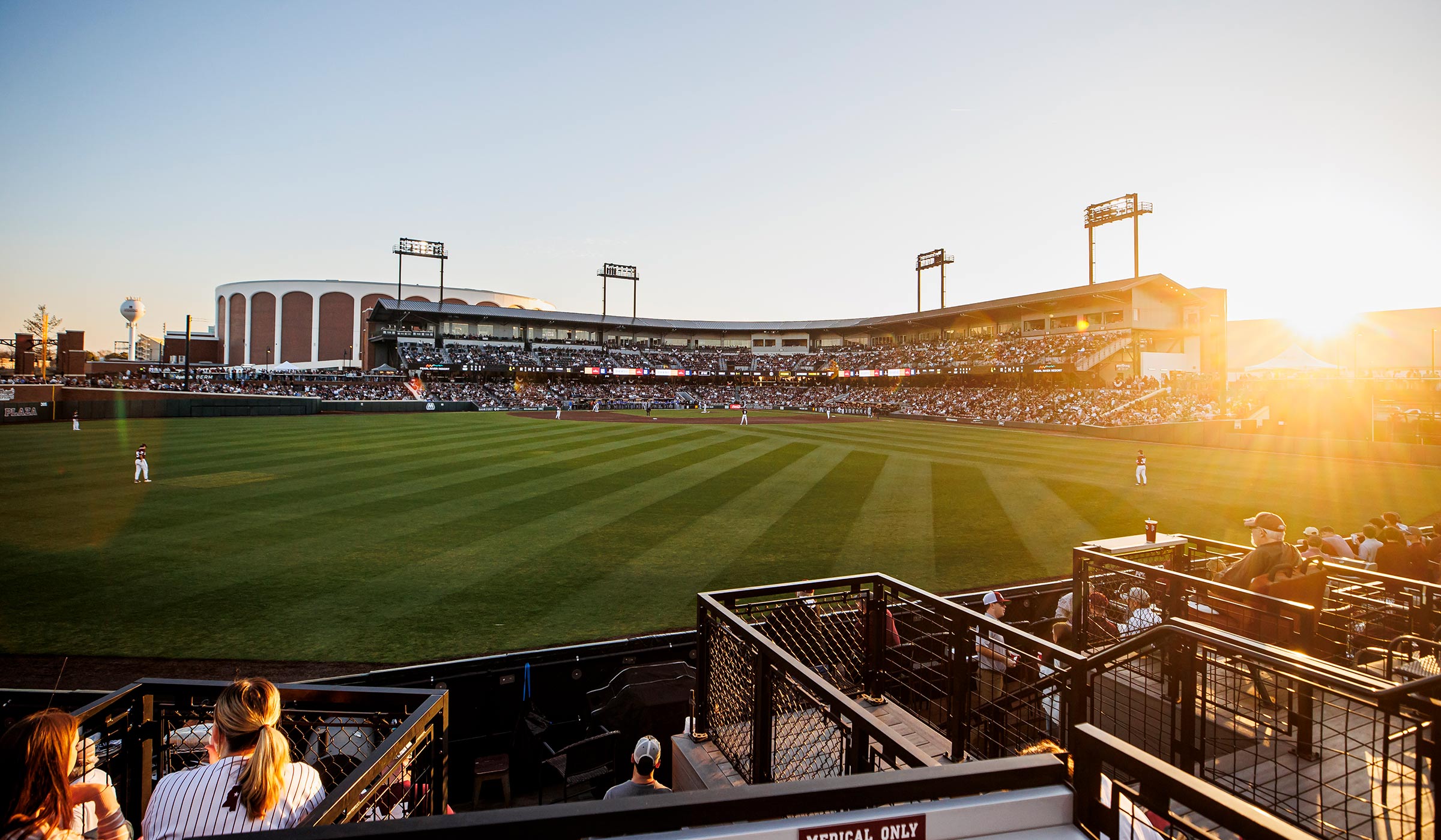 Sunset behind the grand stand of a baseball stadium