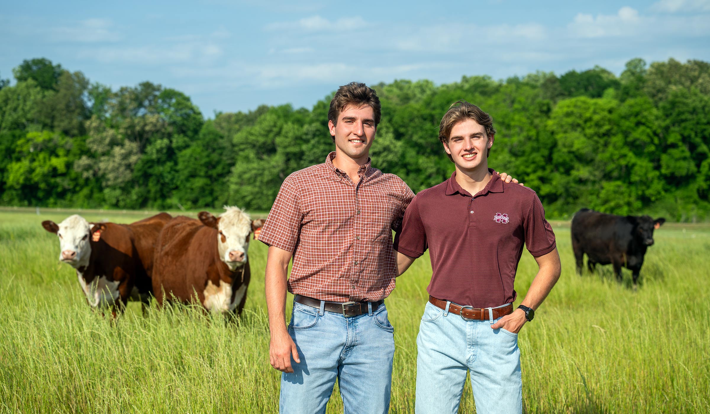 two young men standing in a field