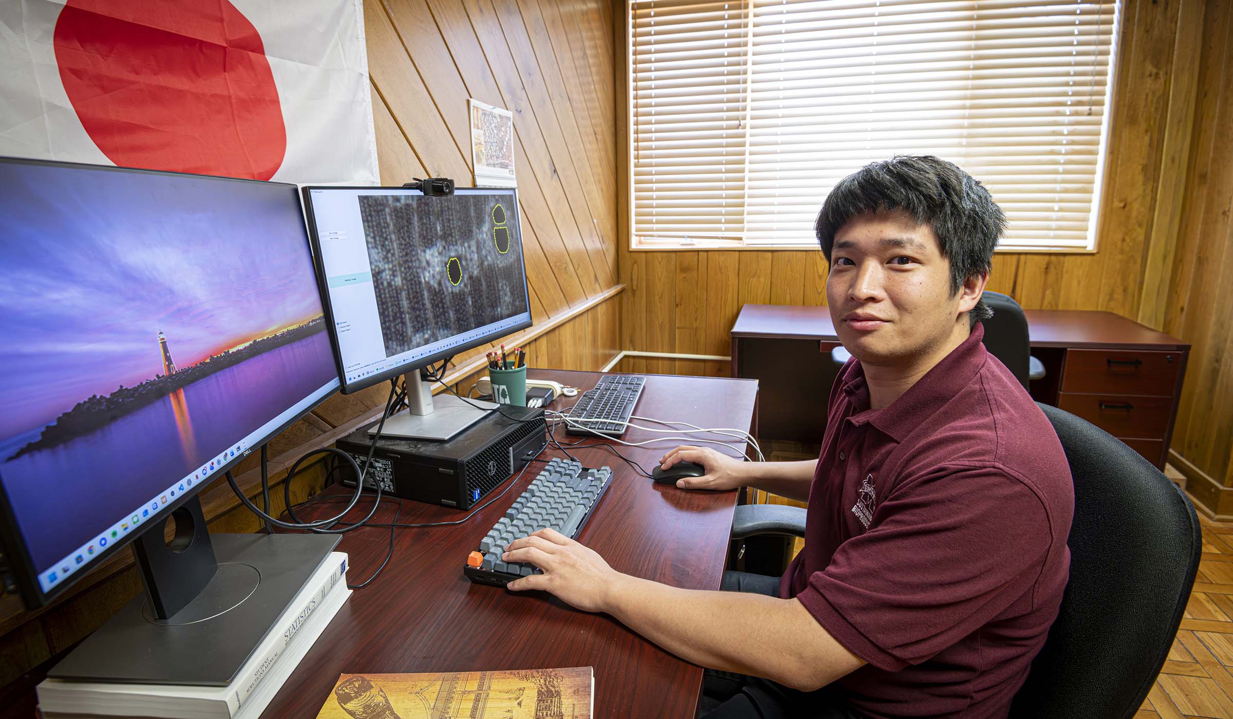 Taketo Nishida works at a computer.