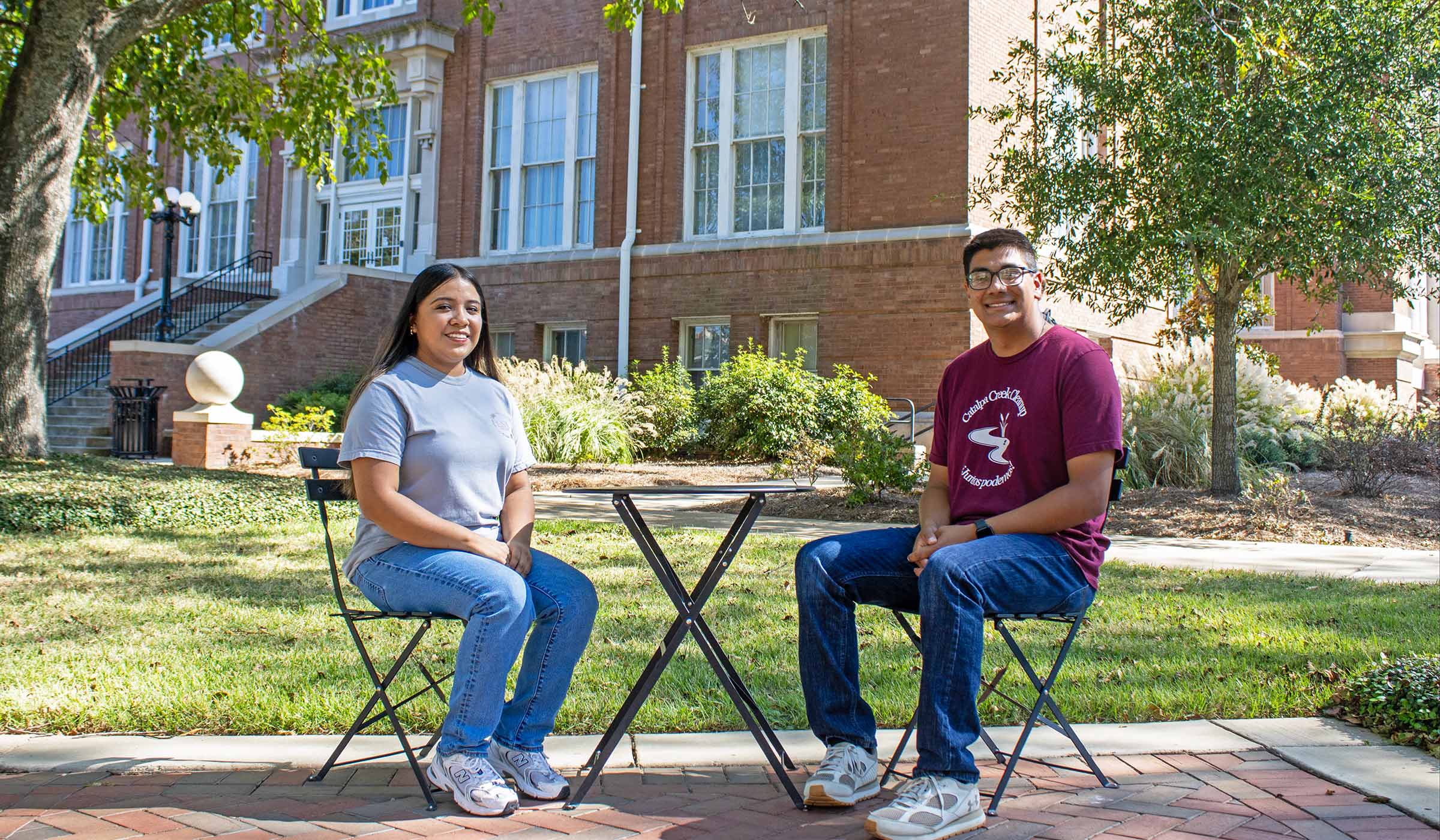 Amy Mata and Carlos Hurtado sitting on the drill field