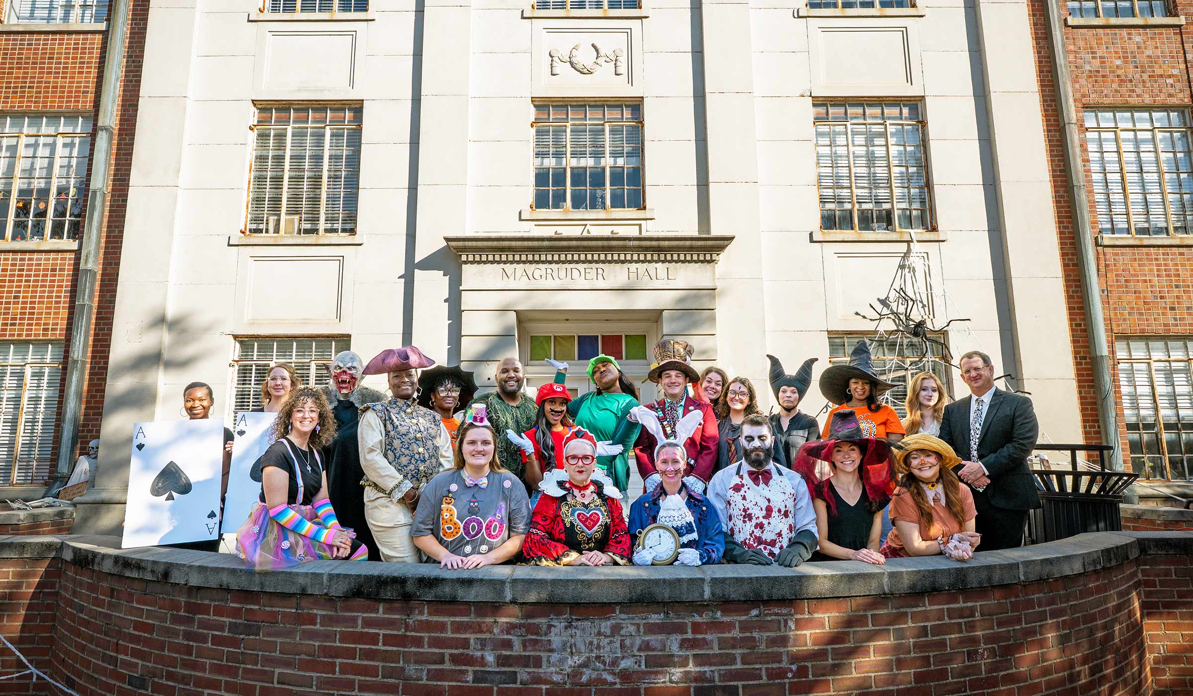 Staff of the Graduate School, dressed for Halloween, pose for a group photo in front of Magruder Hall.