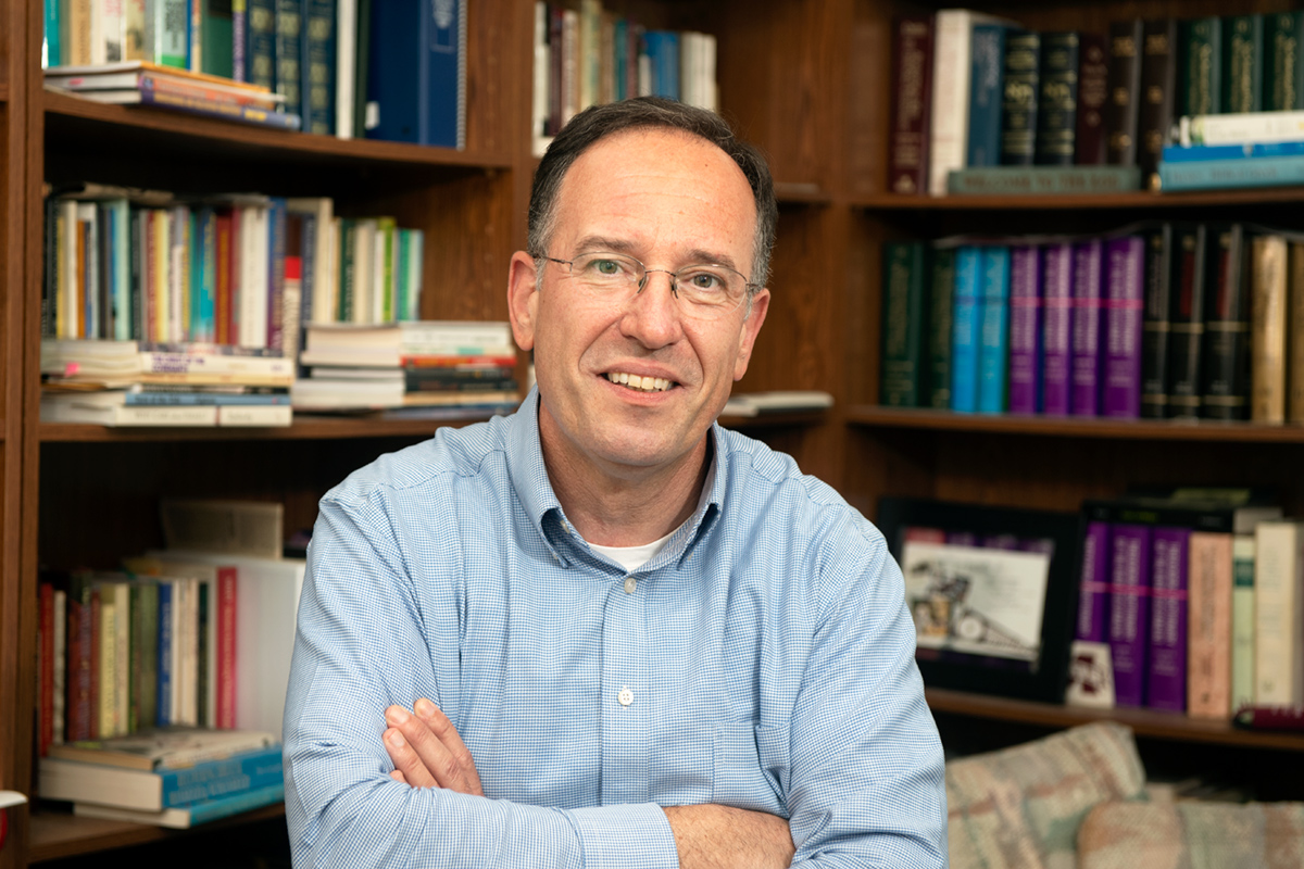 Albert Bisson, pictured surrounded by books in his office.