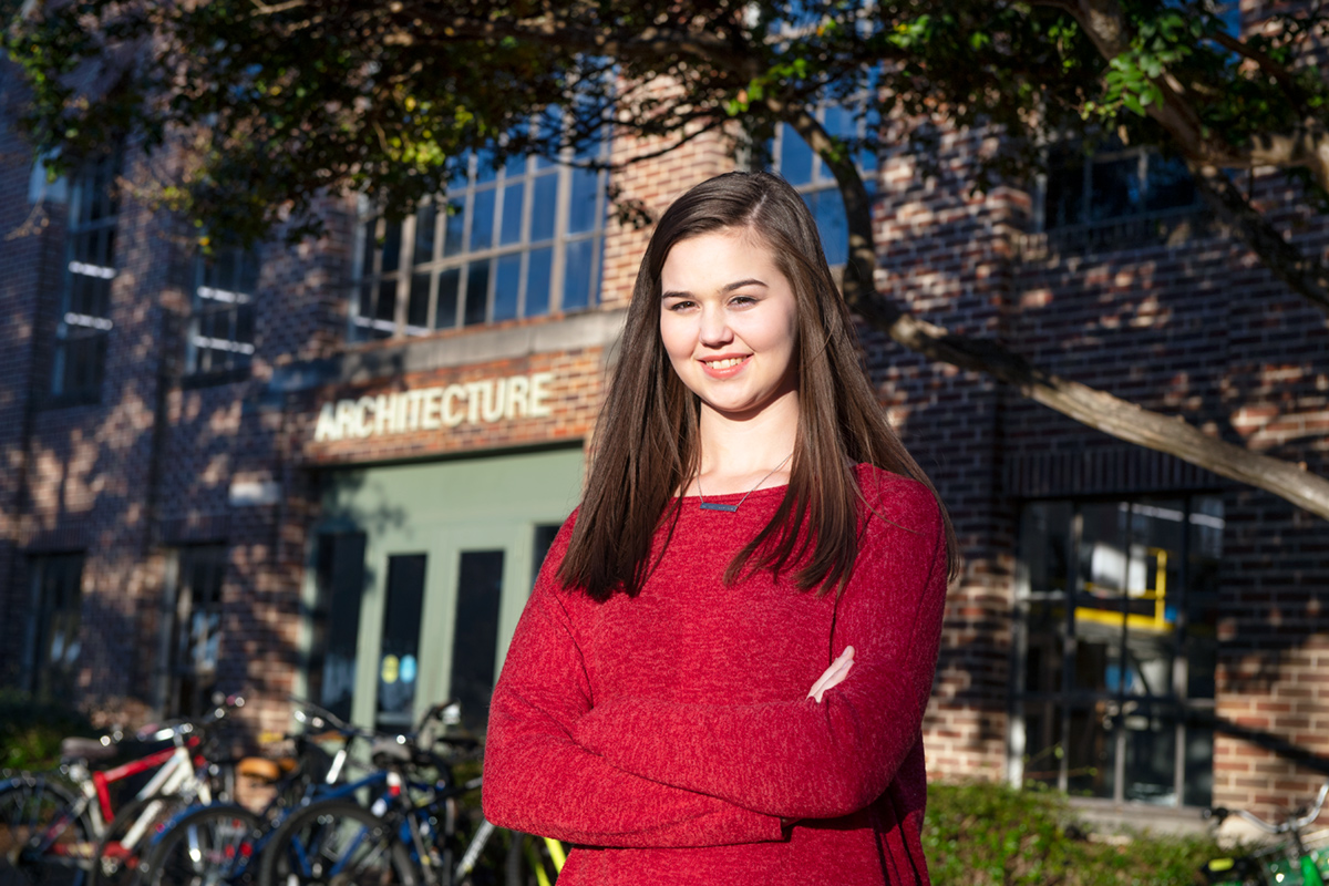 Abby Jackson, pictured outside of Giles Hall on a fall day.