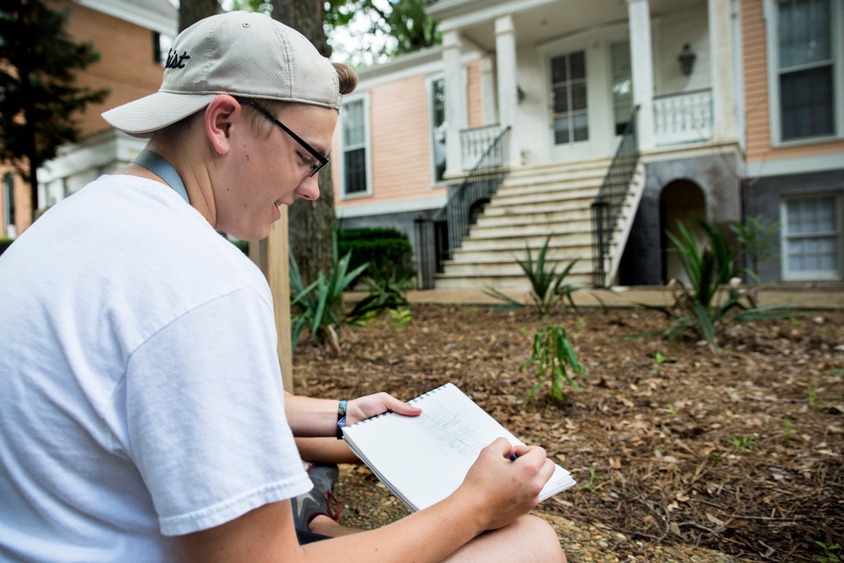 Thomas Boettner sketches the house in front of him for an assignment