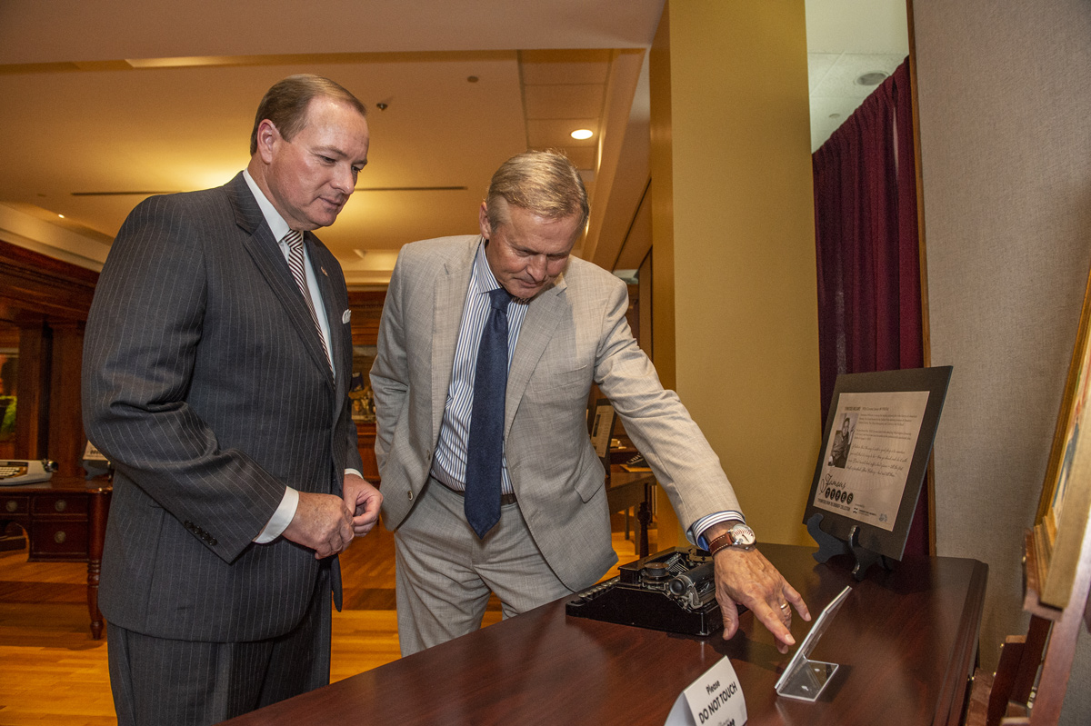 MSU President Dr. Mark Keenum and Author John Grisham view the &amp;quot;Famous Types&amp;quot; exhibit in the John Grisham Room.