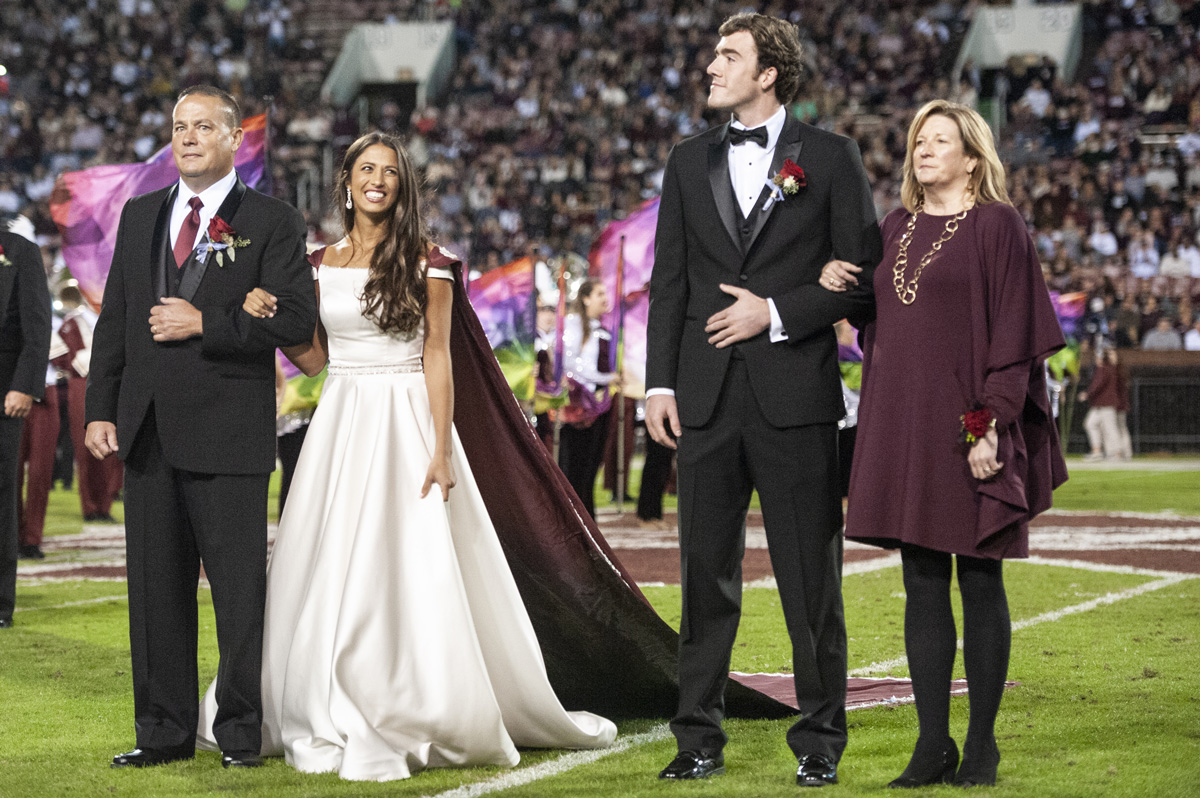 Homecoming Queen Emily Turner and Homecoming King Barrett Schock pose at midfield.