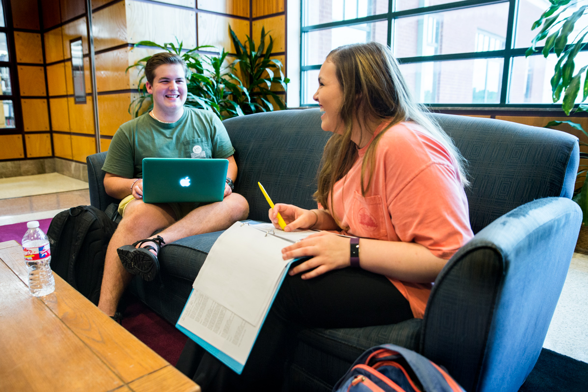 rural medical scholars students study and share a laugh in the library