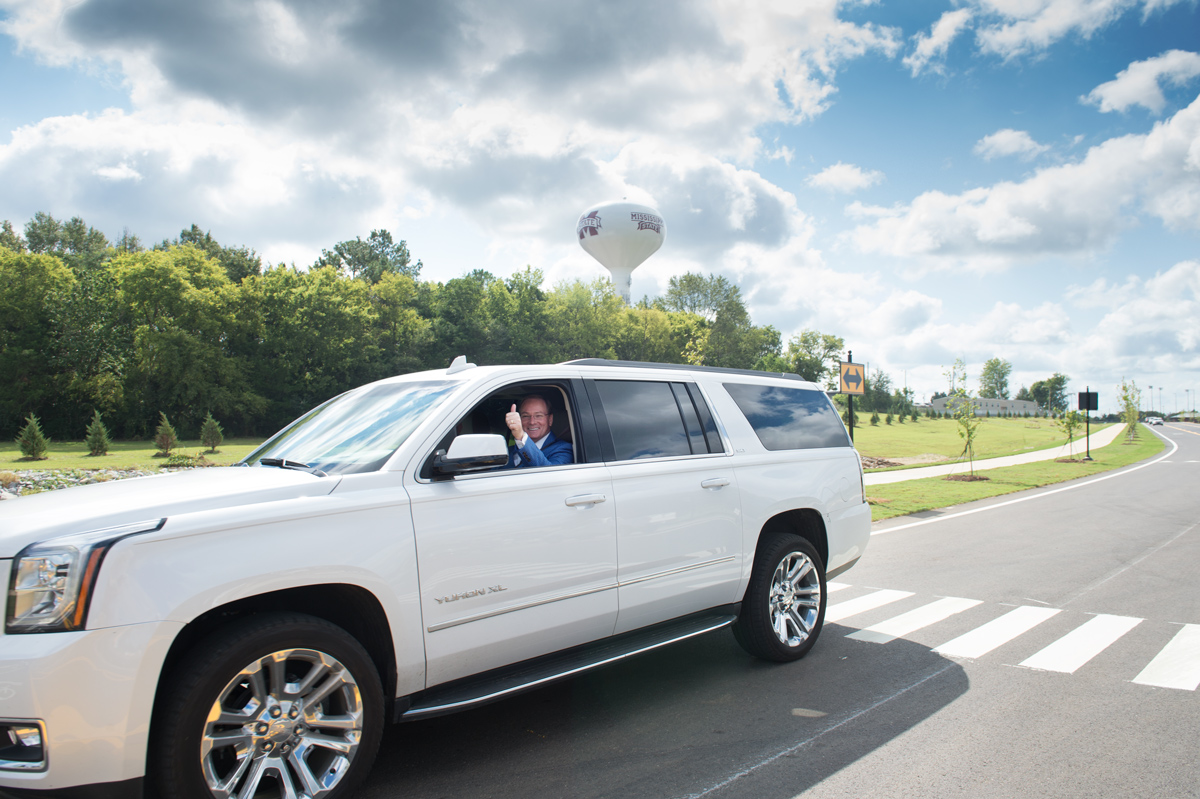 President Keenum gives a thumbs-up through his car window after driving the length of the new Hail State Boulevard.