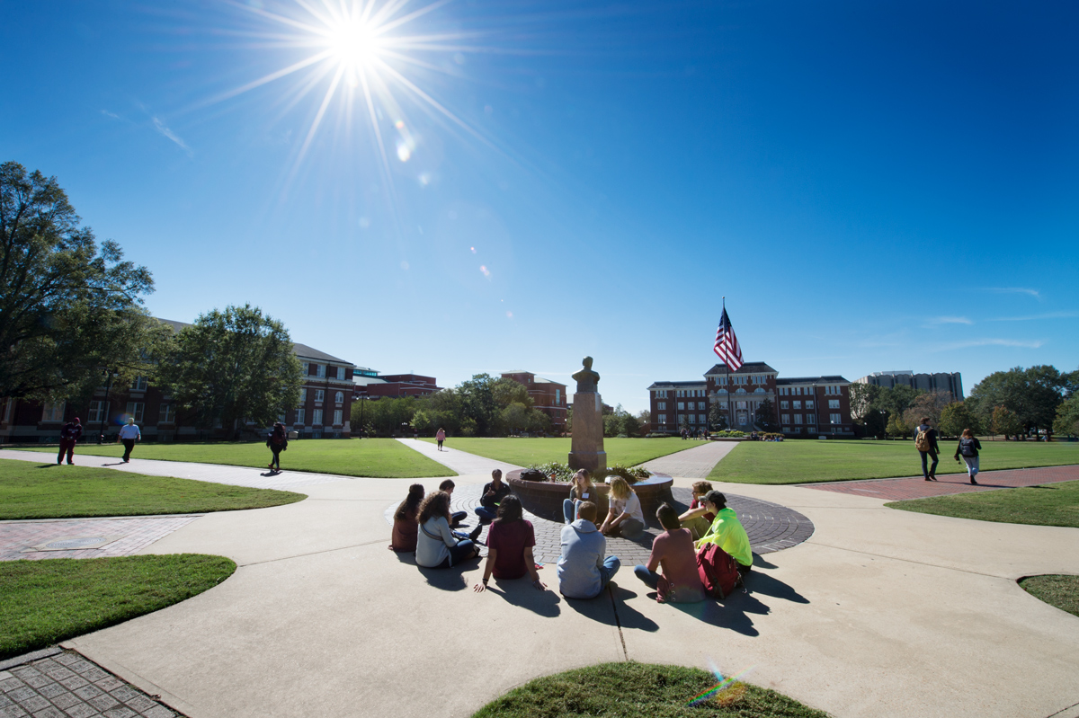 A circle of prospective MSU students gather for a Preview Day breakout session next to the Drill Field&amp;#039;s Stephen D. Lee statue.