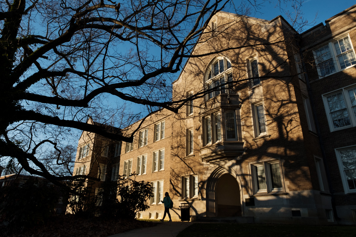 Front entrance of Harned with long sunset light raking across it and blue wintery sky.