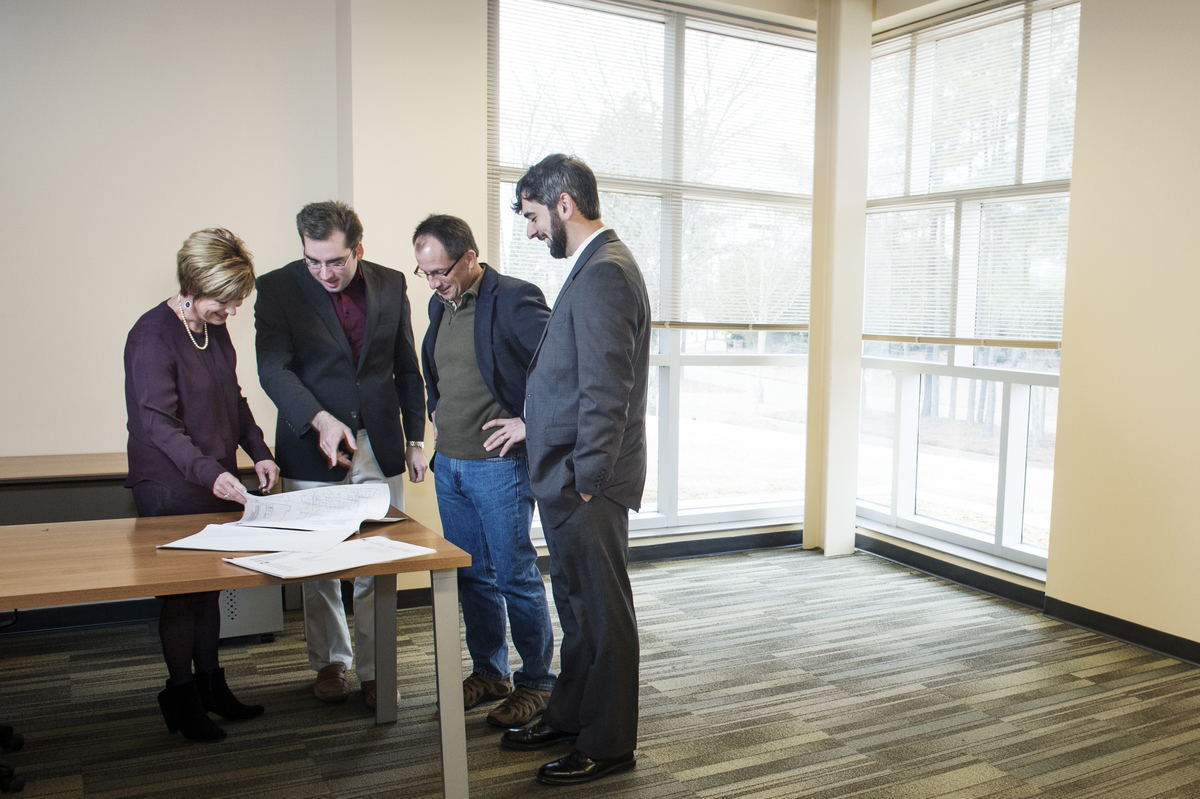 Discussing plans for the MaroonX Accelerator Program are Mississippi State University College of Business Dean Sharon Oswald (from left); Eric Hill, program manager for the Center for Entrepreneurship and Innovation; Jeffrey Rupp, outreach director for the Division of Business Research; and Bryan Patton, graduate associate for entrepreneurship.