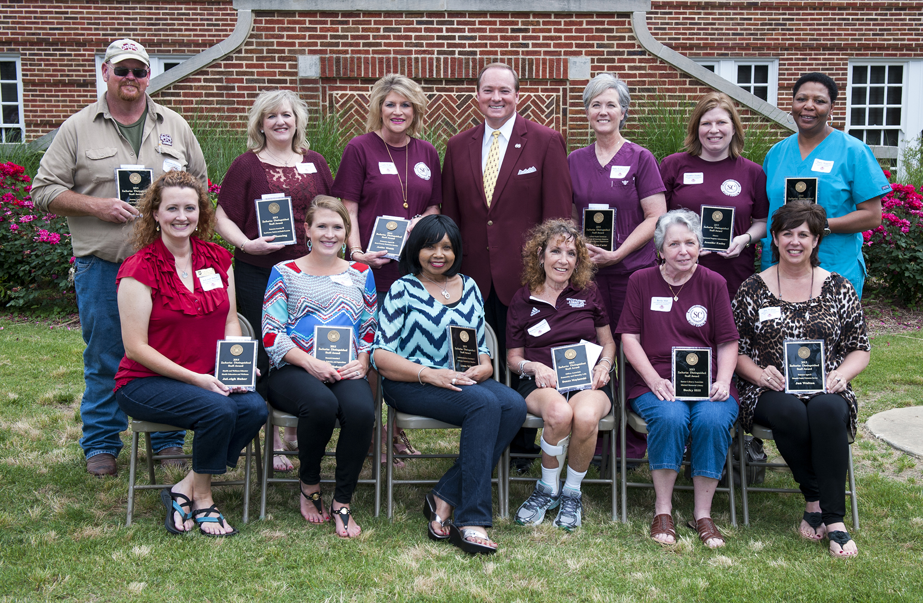 MSU's newest Zacharias Staff Award winners include (front, l-r) JuLeigh Baker, Beth Baker, Linda Miller, Donna Maykowski, Becky Hill, Jan Walton, (back, l-r) Bubba Forrester, Ann Sansing, Anita Webb, Ruby Lynn Carter, Jennifer Easley and Daisy Wiggins. With them is (back, center) President Mark E. Keenum.