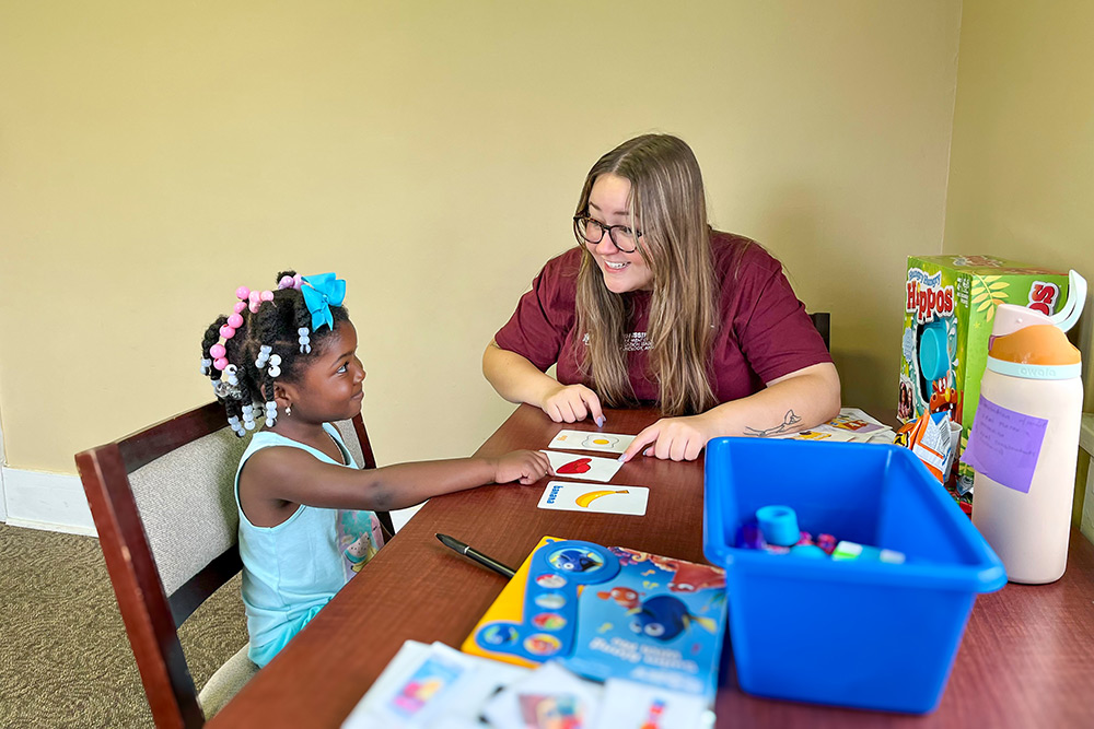 Master's student works with a child