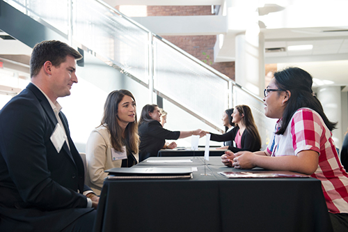 Vy Nguyen, right, a sophomore accounting major at Mississippi State, meets with representatives from HORNE LLP during a recent on-campus networking event. MSU’s Adkerson School of Accountancy is updating its undergraduate and graduate programs to give students the tools needed to remain leaders in the accounting profession. (Photo by Megan Bean)