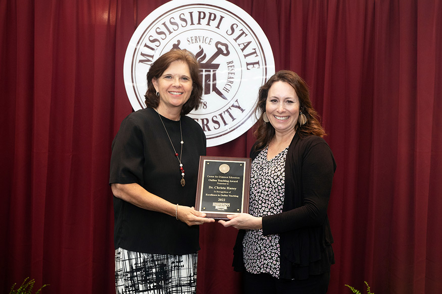 Susan Seal presents Christa Haney the Online Teaching Excellence Award