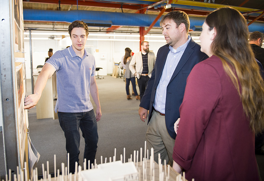 Mississippi State University senior architecture students Maxwell J. “Max” Wilson of Spring Hill, Tennessee, left, and Shelby G. Christian of Vancleave discuss their proposal for a forestry and wildlife outreach center in Flowood with Mississippi Forestry Association Executive Vice President J. Tedrick Ratcliff Jr. The project was part of MSU Assistant Professor Jacob A. “Jake” Gines’ fall-semester introduction to mass timber studio course that is made possible with support from the Mississippi Forestry Foundation, the fundraising arm of the MFA. (Photo by Russ Houston)