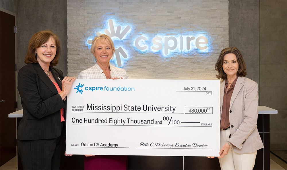 Mississippi Department of Education Chief Academic Officer Donna Boone, left, and MSU Center for Cyber Education Director Shelly Hollis, center, accept a donation from C Spire Foundation Executive Director Beth Pickering to support the development of online K-12 computer science courses for Mississippi students. (Photo courtesy of C Spire)