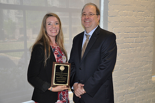 Mississippi State Department of Communication Instructor Cheryl Chambers receives the College of Arts and Science’s inaugural Distinguished Service Award from Dean Rick Travis.