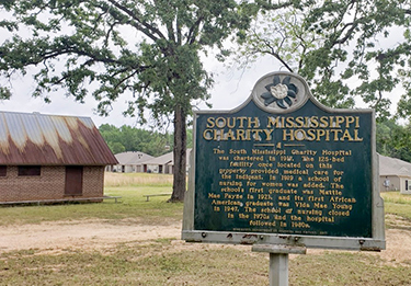 A historical marker for the Old Charity hospital site in Laurel