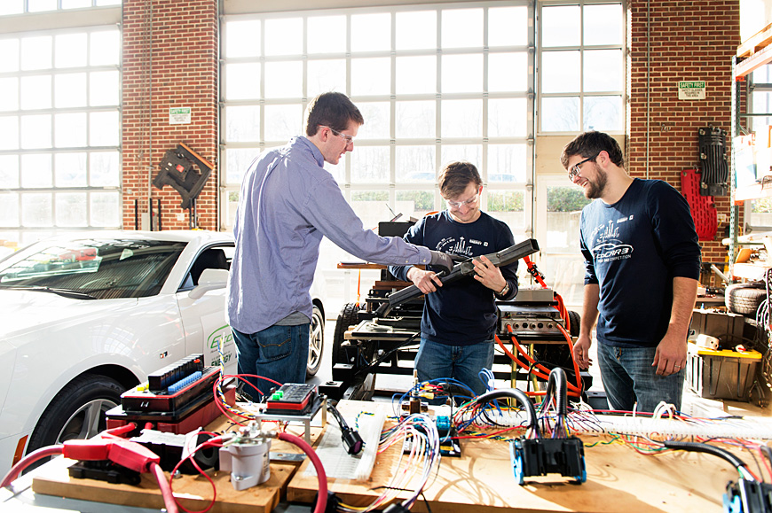 Mississippi State EcoCAR 3 team leaders (l-r) Jared Oakley, a mechanical engineering graduate student from Kennesaw, Georgia, and Alex Gibson and John Corn, both electrical and computer engineering graduate students from Meridian, work on parts for the team’s project car. During the course of the four-year competition, the team plans to modify a 2016 Chevrolet Camaro to achieve 65 miles per gallon highway fuel efficiency without sacrificing performance. (Photo by Beth Wynn)